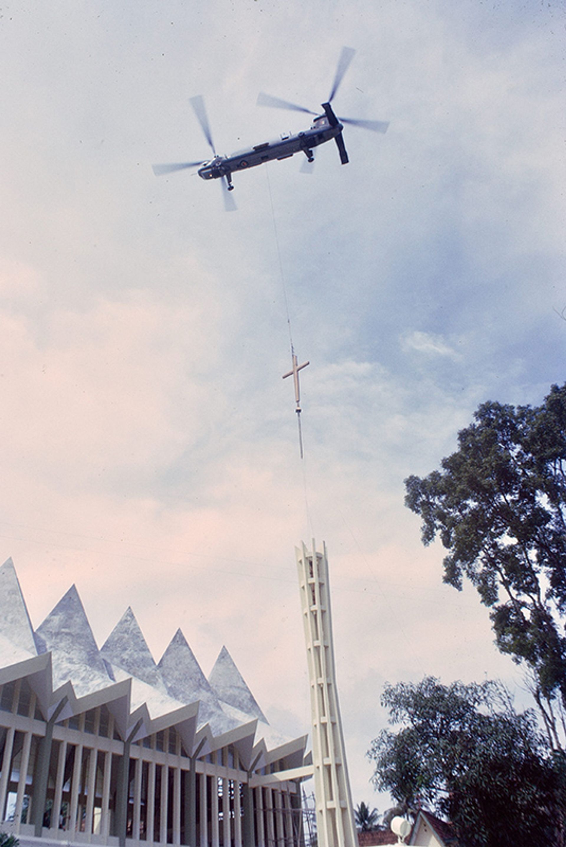 A Royal Air Force (RAF) helicopter, lowering and positioning the 1,000kg aluminium cross of the new Hakka Methodist Church in Newton. The precision exercise was undertaken by a Belvedere helicopter of the 66th Squadron, RAF Seletar on Dec 15, 1966.