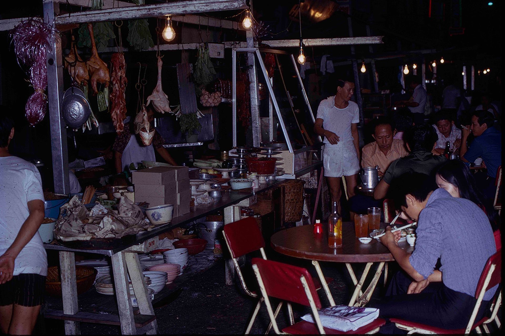 In the evenings, the usually sedate Albert Street and Bugis Street are transformed into open-air restaurants, with some of the most delectable and affordable cooked food stalls on the island. This photograph was taken in September 1971.