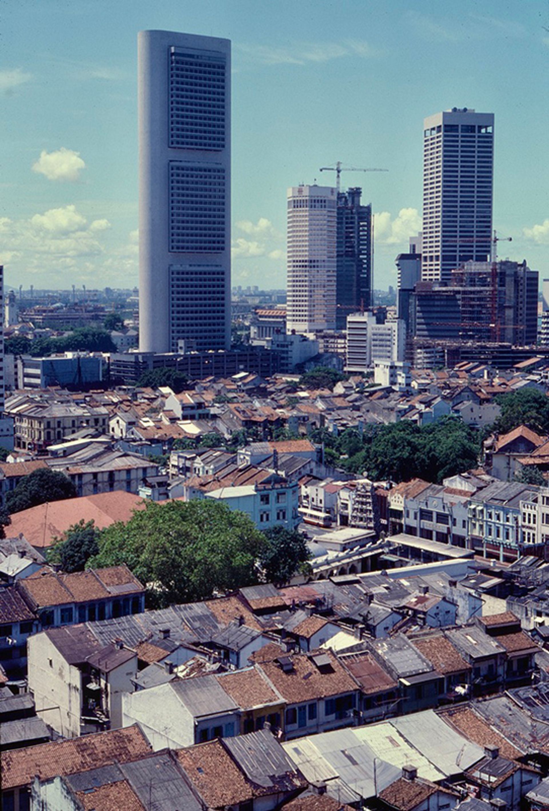 An aerial view of part of Chinatown from People’s Park Centre, looking down towards Boat Quay whose skyline is dominated by the OCBC Centre, circa 1975. The Sri Mariamman Temple on South Bridge Road can be seen in the foreground.