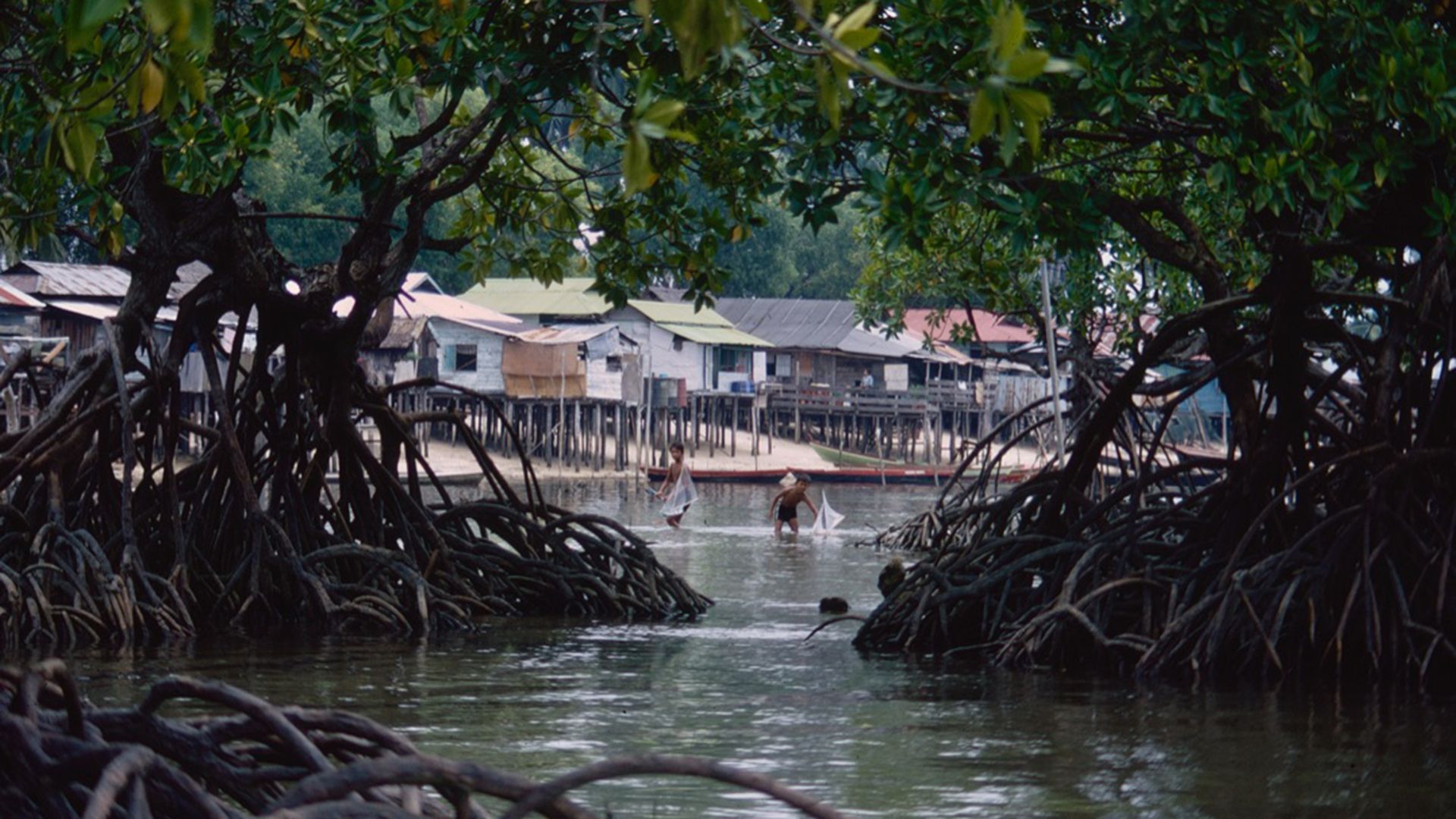 Children playing with their model boats, known as jongs, in shallow water in Pulau Sudong, part of the Southern Islands, in the 1970s.