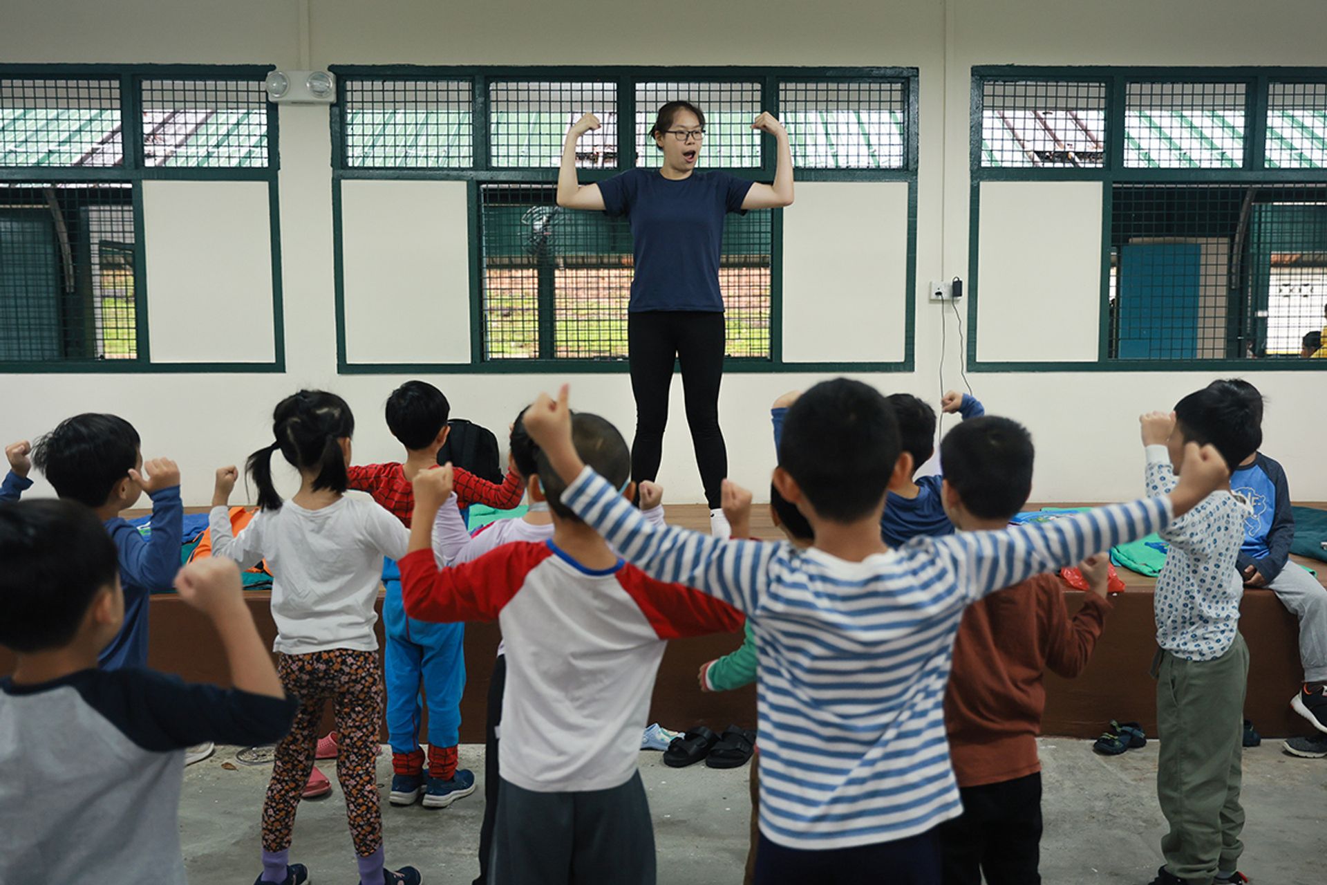 Teacher Samantha Teo, 33, leads the children in a morning exercise after they wake up.