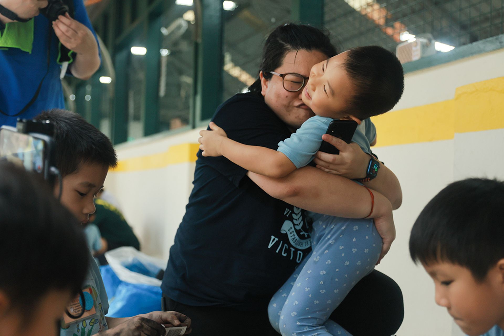 Ms You gives Jacob Zhai a hug after he succeeds on his first try in starting the fire. During practice in school, he had faced several setbacks.