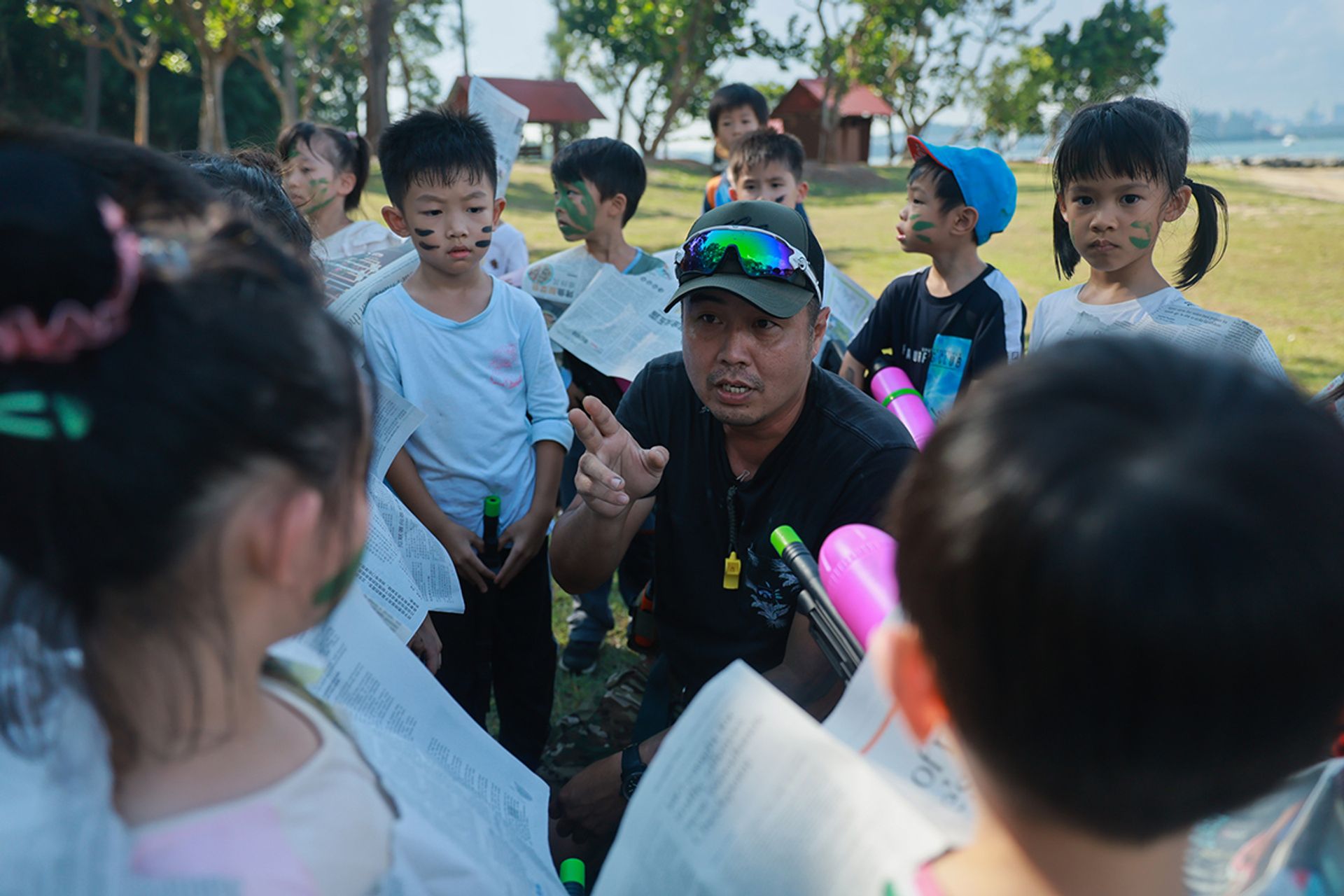 Camp instructor Foo Guo Liang, 44, helps the children to regroup and come up with a strategy to win.