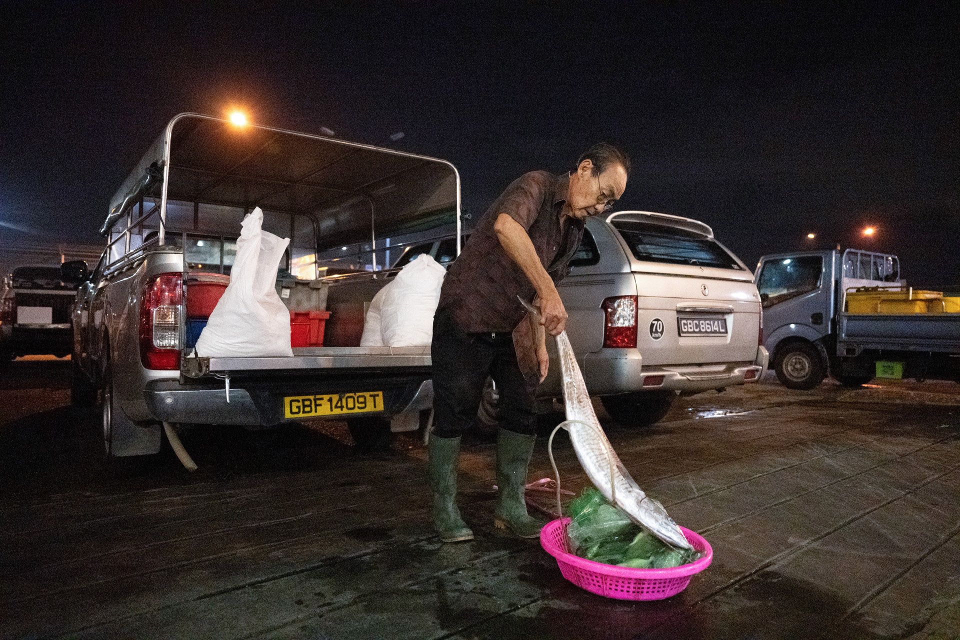 Mr Chia Jim Hiang loading fish before driving to his fish stall at Ang Mo Kio Avenue 10.