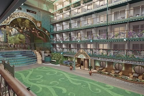 Whimsical indoor atrium with multi-story balconies, green patterned floor, and an arched stage.