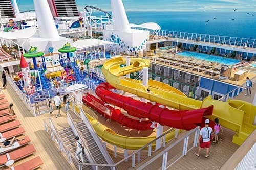 Vibrant cruise ship deck with water slides, a water park, a swimming pool, and ocean views.