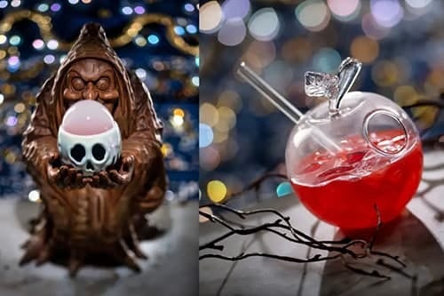 A witch figure holds a glowing skull cup, next to an apple-shaped glass with red liquid and a straw.