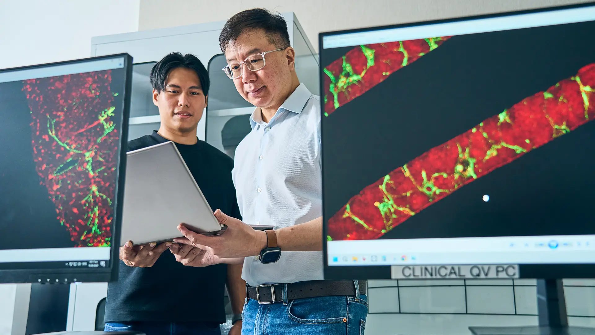 Two men looking at laptop