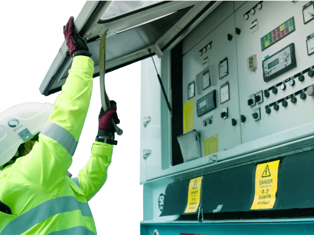 Worker in high-vis jacket and hard hat interacting with an industrial control panel.