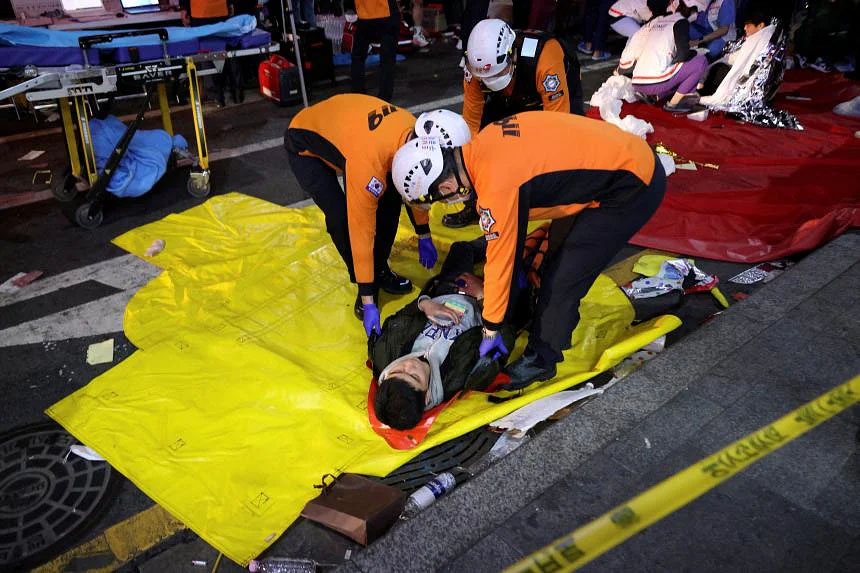 A man receives medical help from rescue team members at the scene. PHOTO: REUTERS