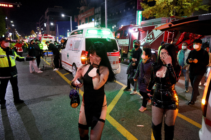 Partygoers, largely teenagers and young people, walk by ambulances at the scene. PHOTO: REUTERS