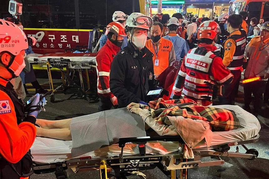 Rescuers move an injured person on a stretcher in Seoul’s Itaewon district. PHOTO: EPA-EFE