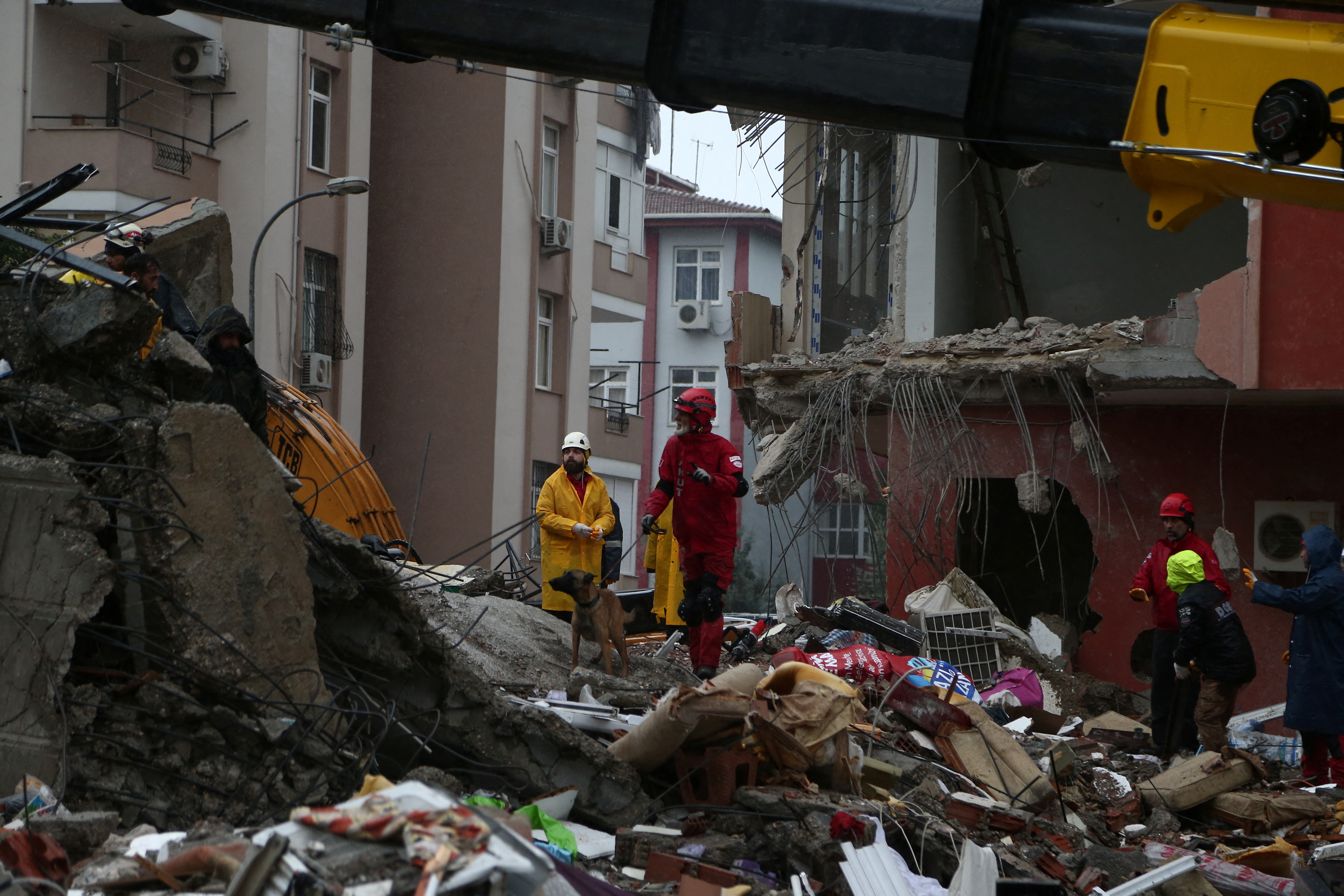 A member of the Turkish Search and Rescue Association with a sniffer dog searching for survivors at the site of a collapsed building following an earthquake in Adana, Turkey, on Feb 6, 2023. PHOTO: REUTERS
