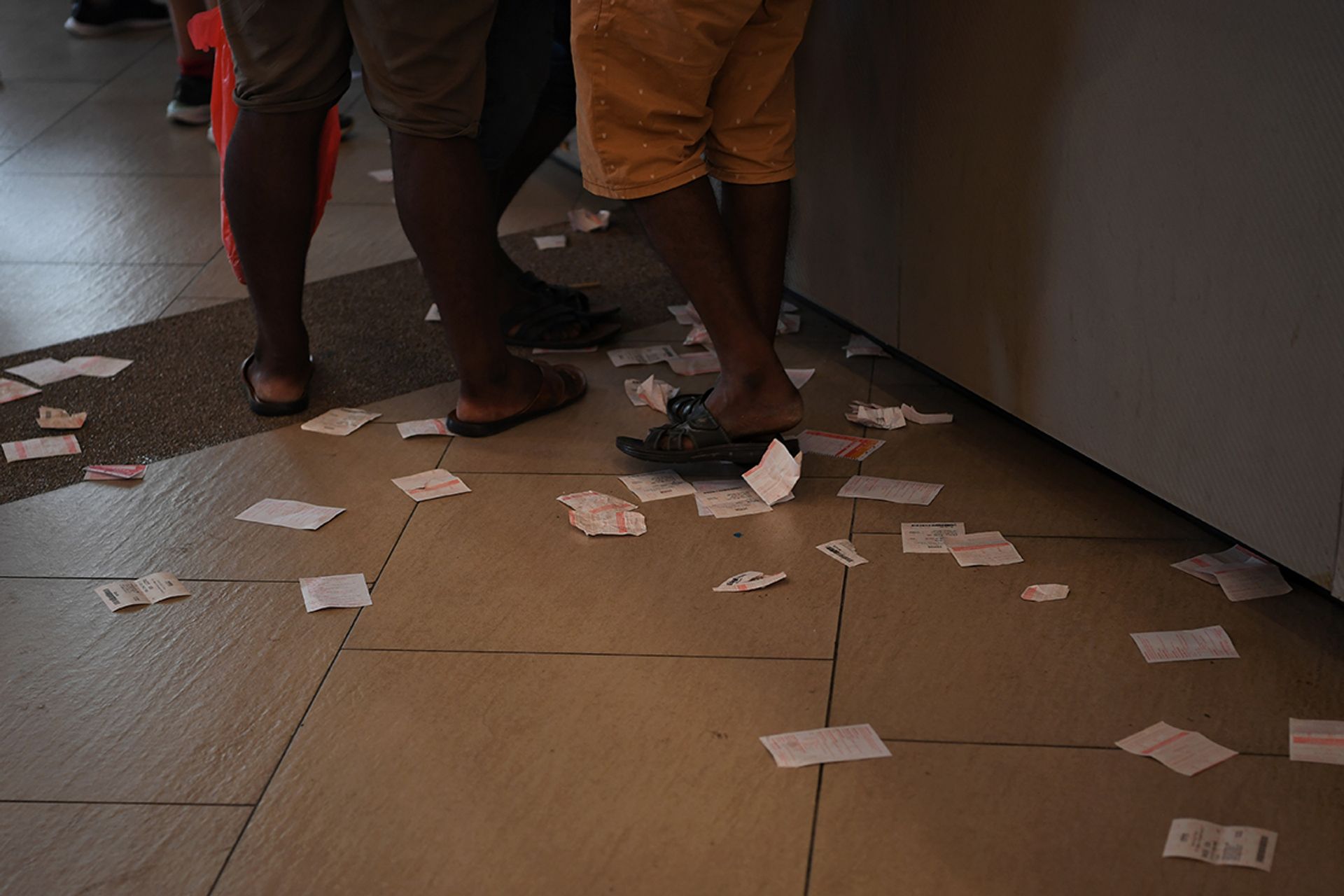 Tossed betting slips on the floor, like confetti of hopes lost. ST PHOTO: SHINTARO TAY