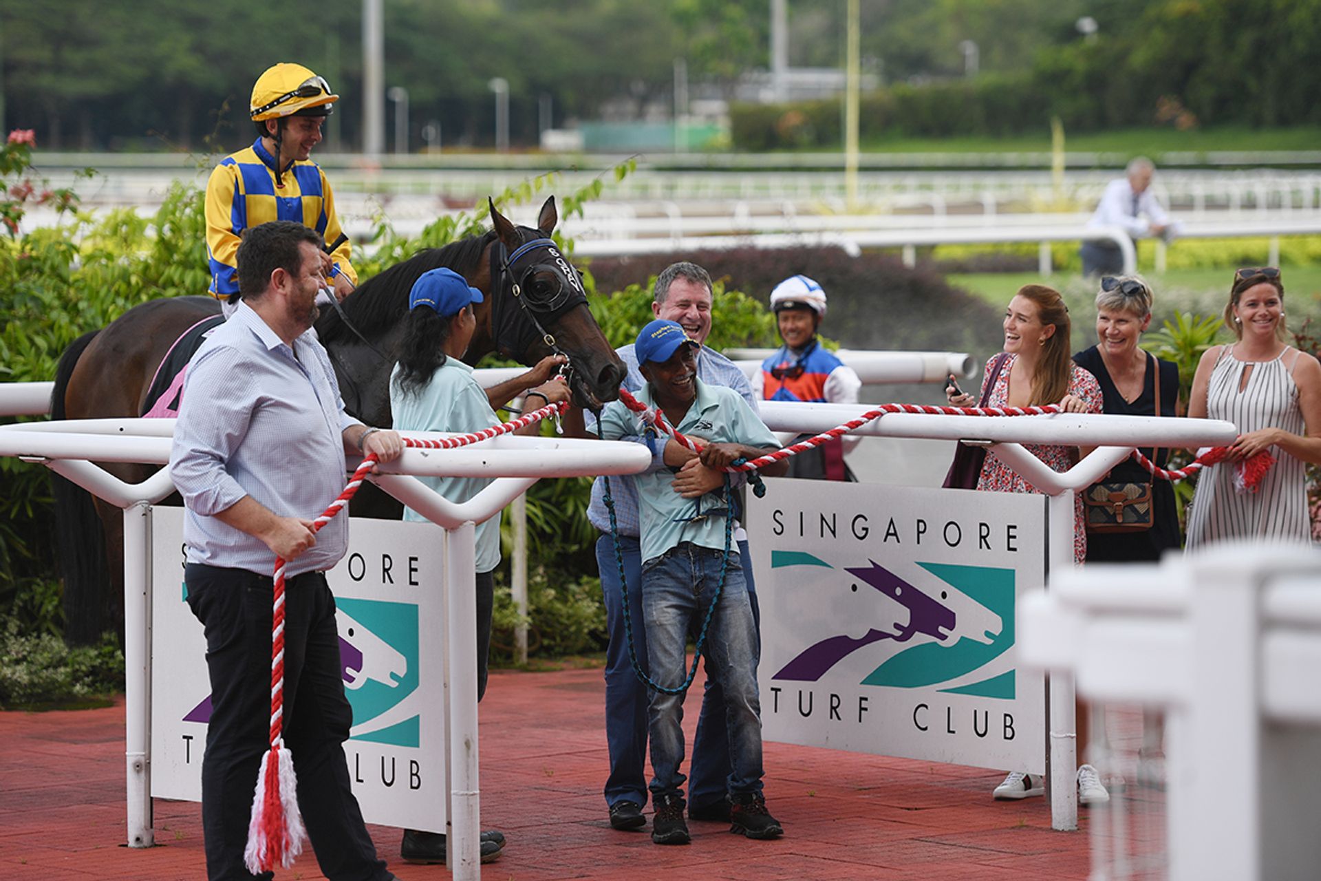 Trainer Stephen Gray hugs a stable hand in triumph at a victory ceremony after his horse Wecando (with jockey Marc Lerner atop) won the ninth race on Sunday. ST PHOTO: SHINTARO TAY