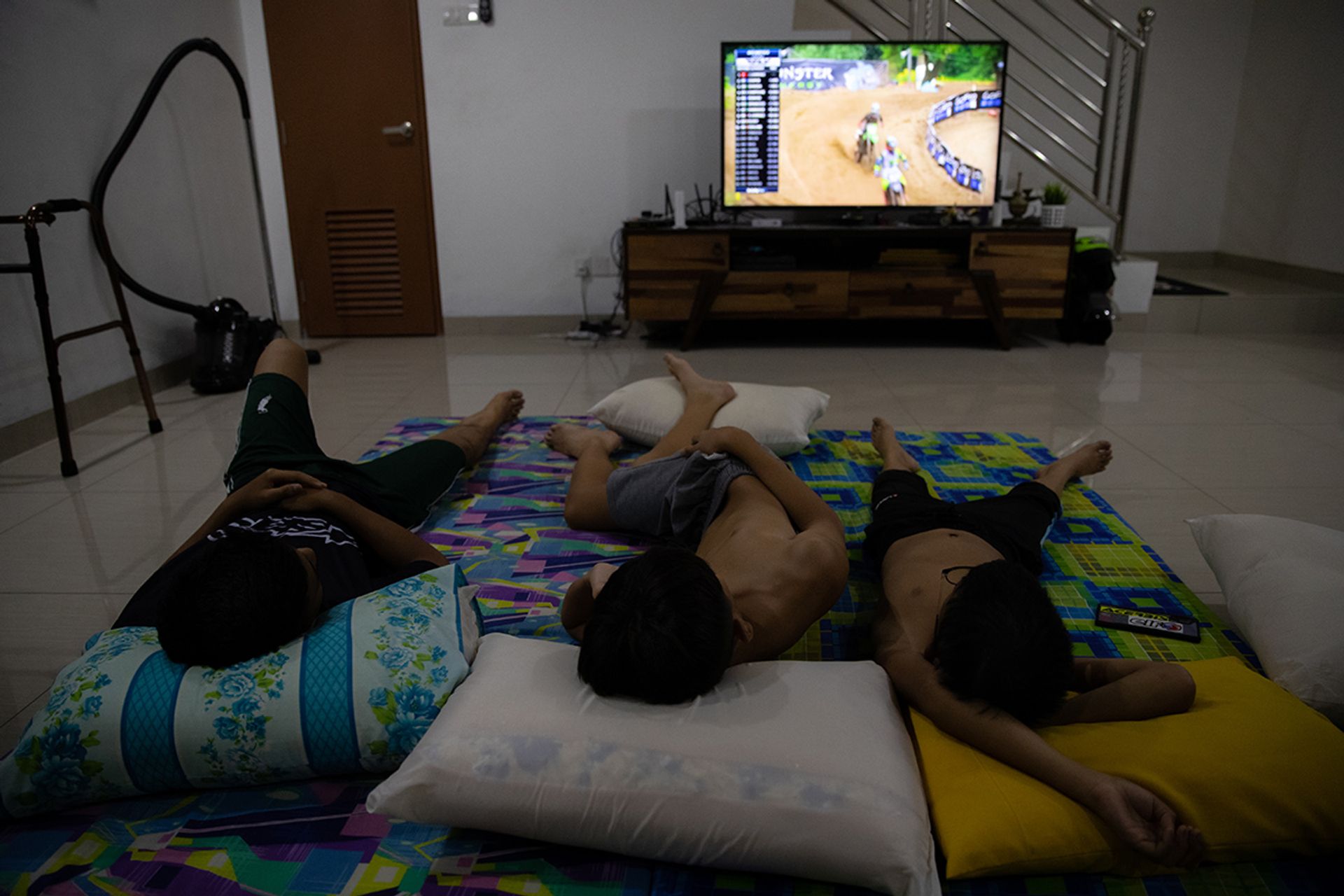 Ian, his riding buddy Seth Loh, 14, and Iman, watching motocross competitions on YouTube before going to bed.