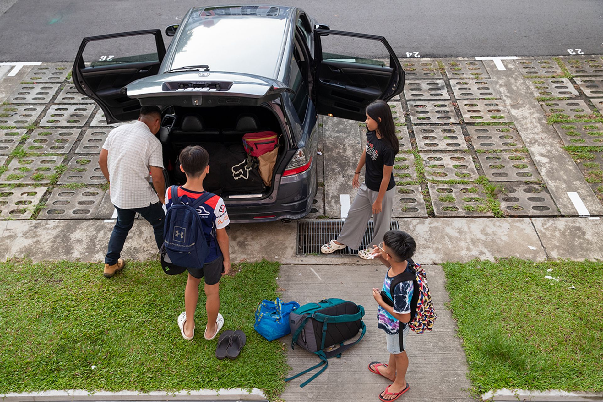 Mr Fazlin squeezing bags and riding gear into the family's seven-seater before they set off for Johor on June 30.