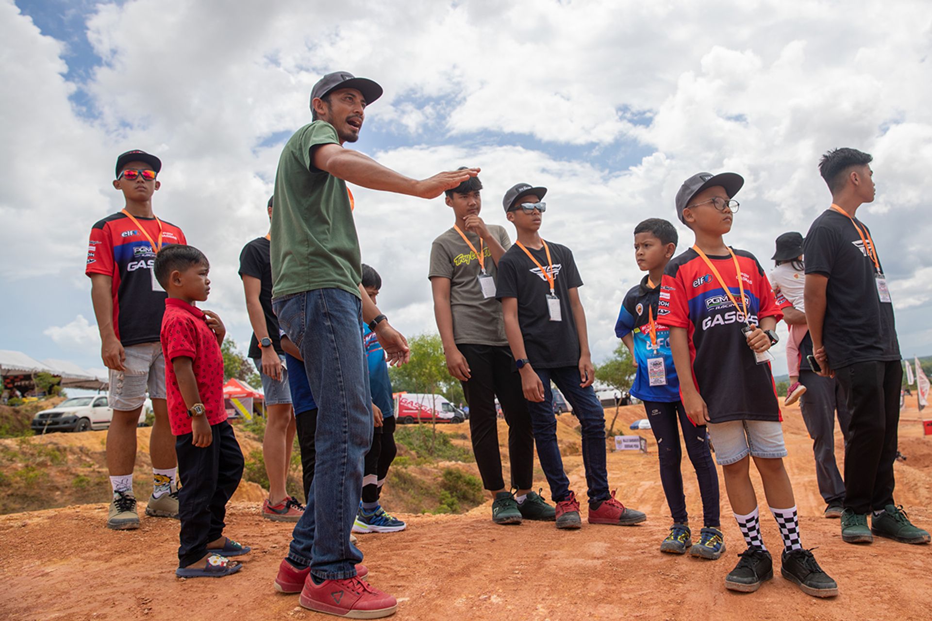 Coach Hazlanshah (in green) telling his riders how they should attack each obstacle and which lines to take during the track walk before first practice on July 7.