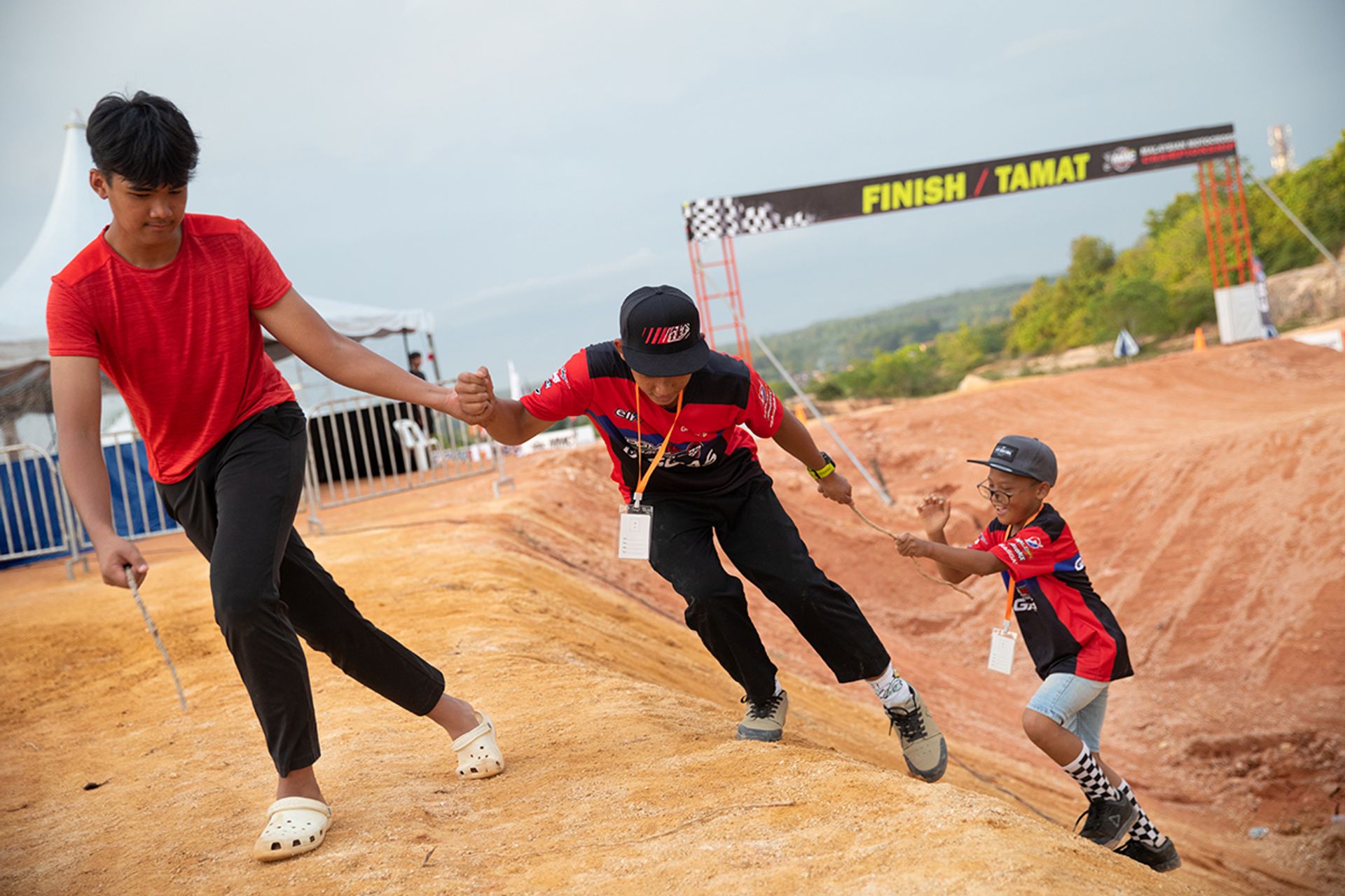 (From left) Nurhaziq, Ian and Iman, who often train together, goofing around by the side of the dirt track at Penang where the opening leg of the Malaysian Motocross Championship (MMC) was held.