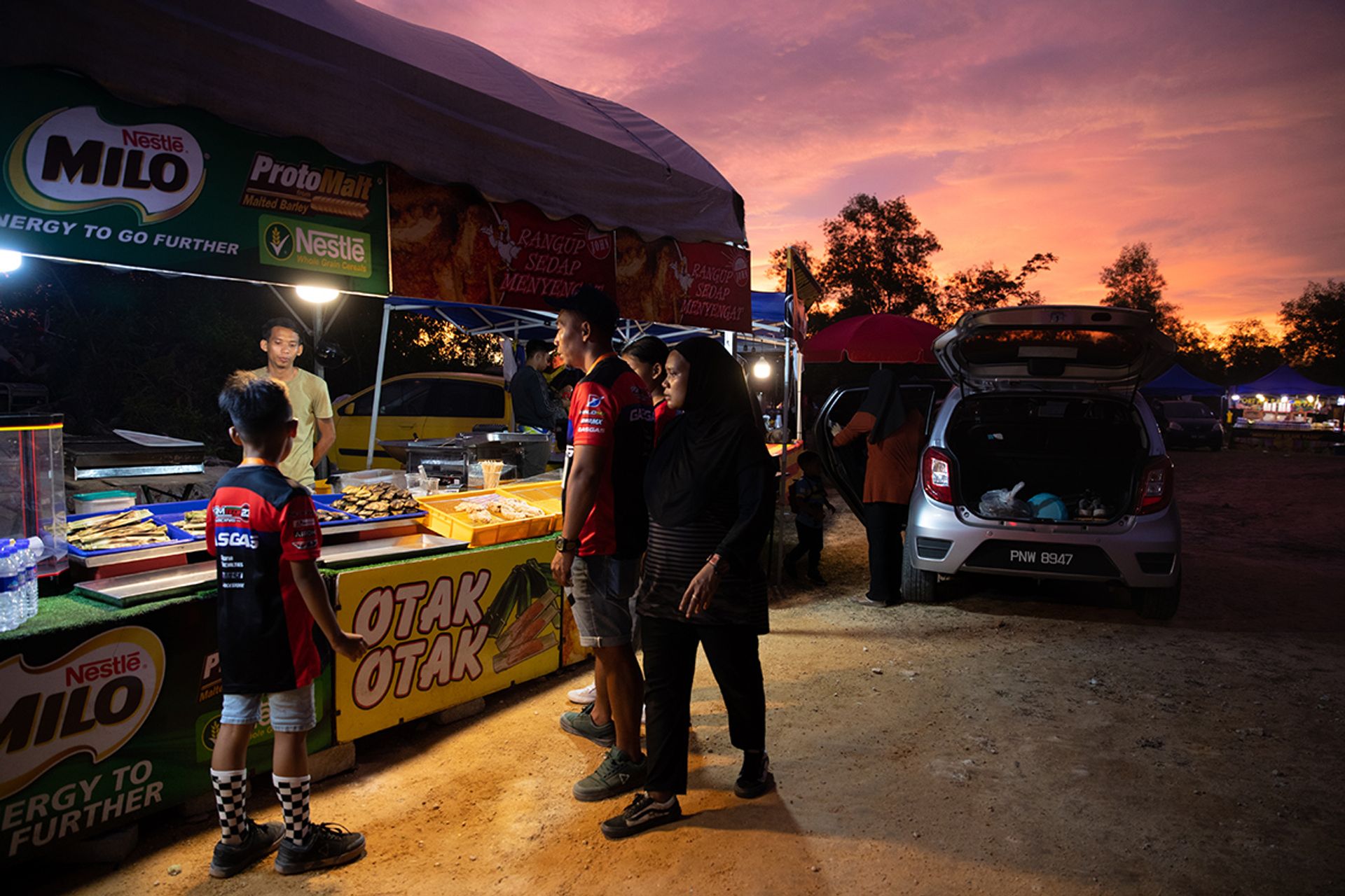 The family buying food and drinks for the racing team’s mechanics on July 7.