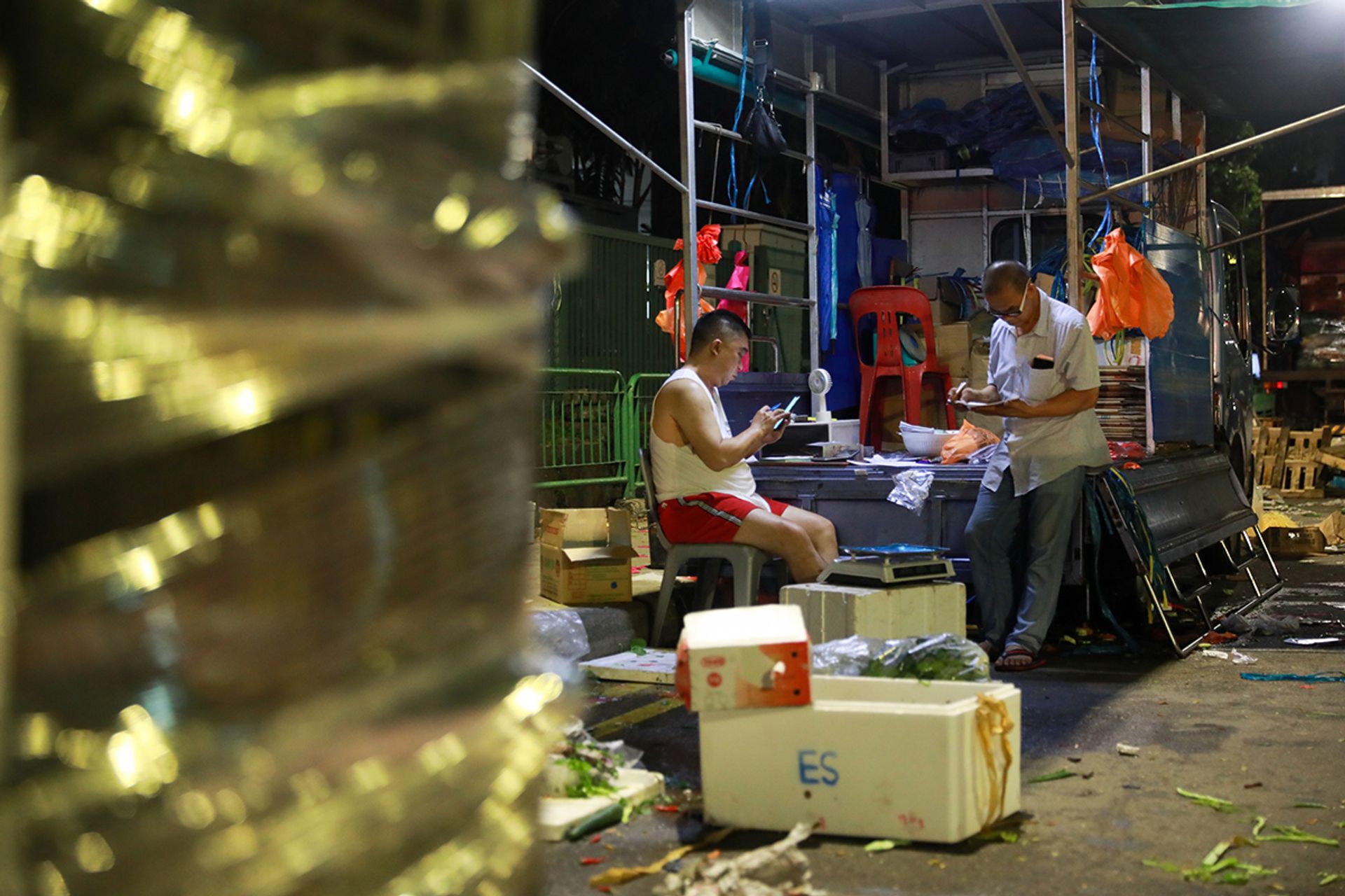After a busy night, second-generation stall owner Ong Chai Meng (left), 52, and Mr Chan tally their records in the wee hours of May 6. Mr Ong first began helping out at his father’s stall during the primary school holidays more than four decades ago.