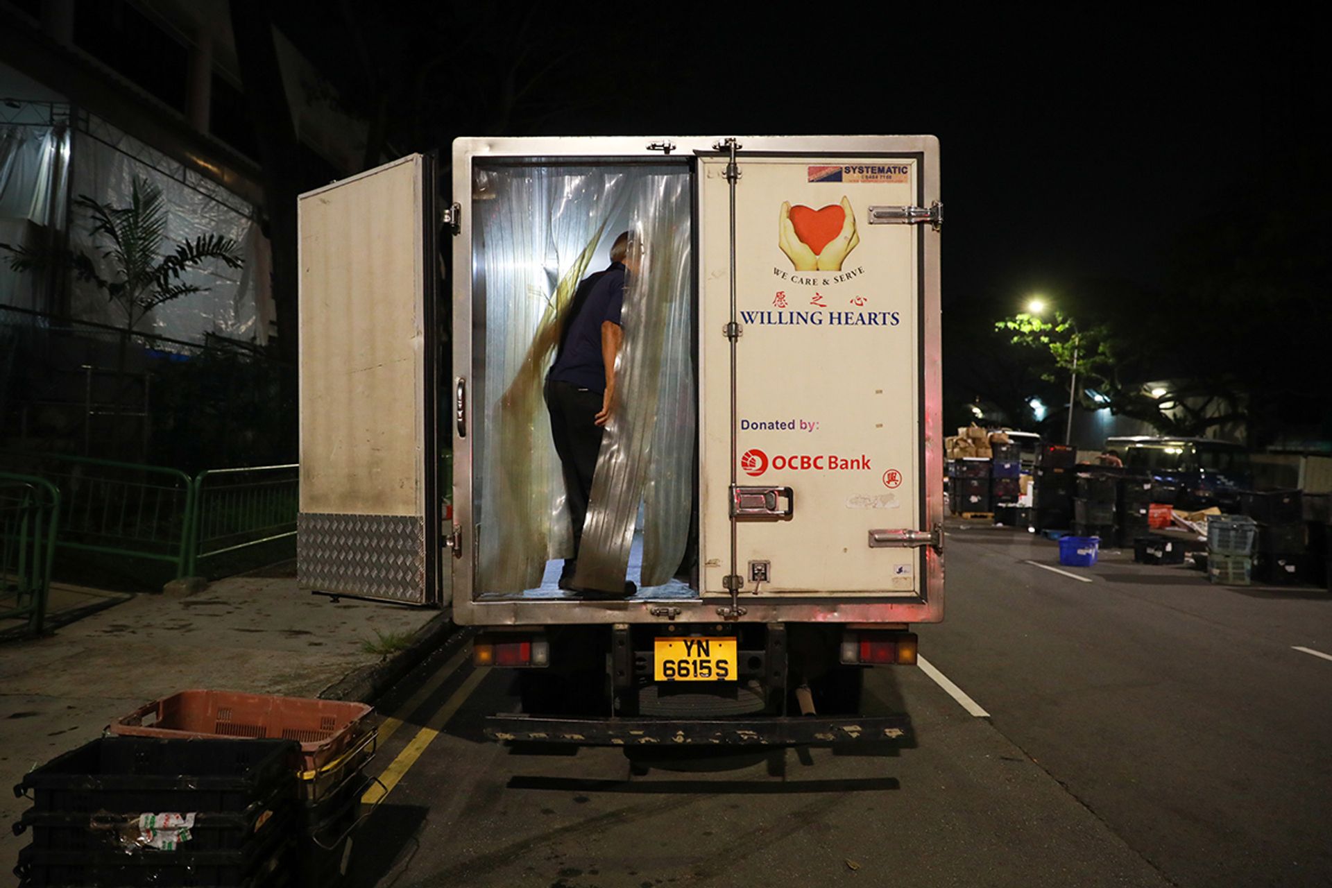A representative from Willing Hearts loading up a lorry with unsold vegetables just before dawn on May 6. “At least the vegetables don’t go to waste,” said wholesaler Ong Chai Meng when The Straits Times asked about the initiative. “It’s a small thing lah.”