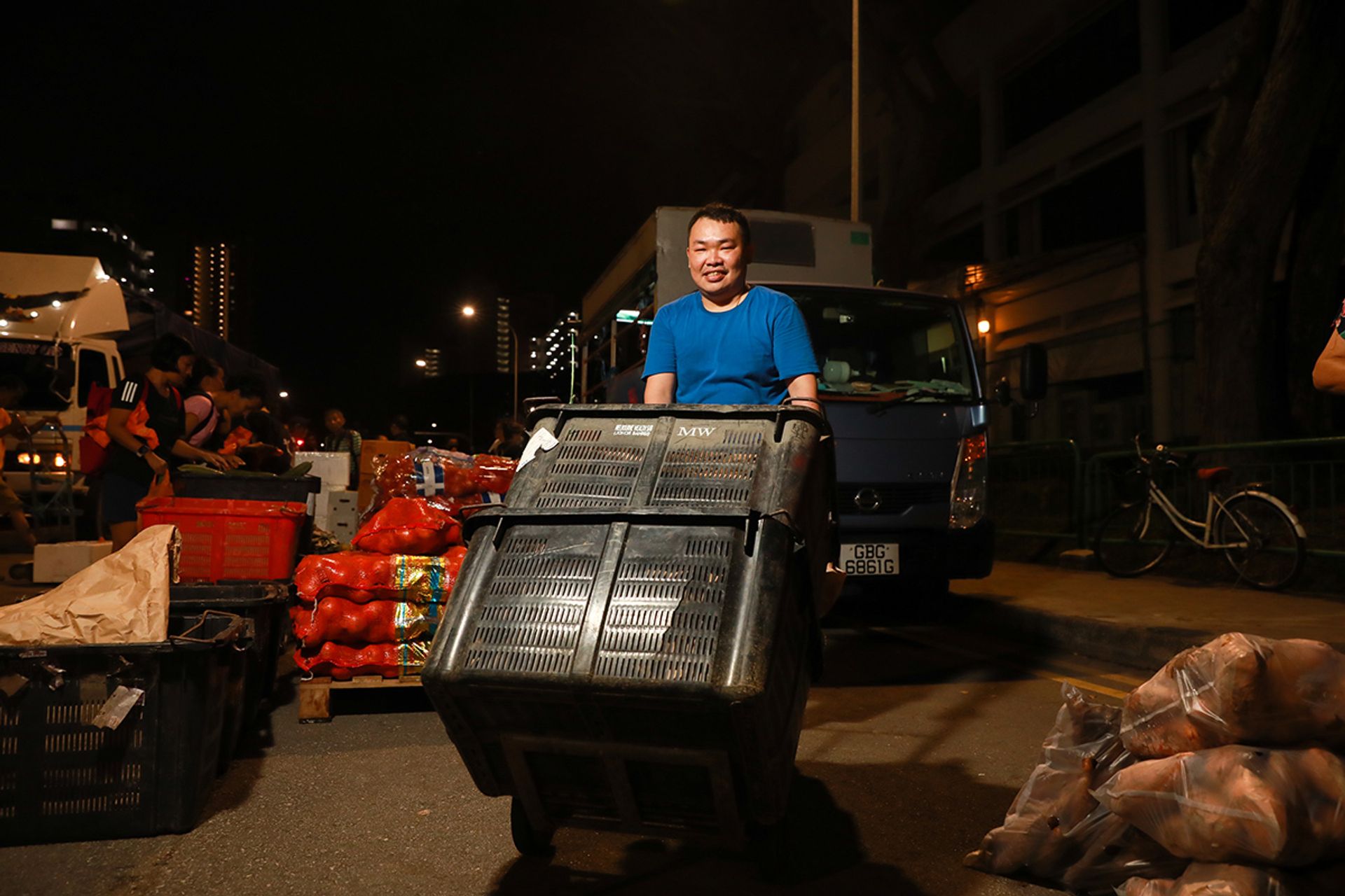 Another worker Tan Teng Kuan (in blue), 33, moves about 20 pallets of vegetables in one night, each weighing above 100kg.