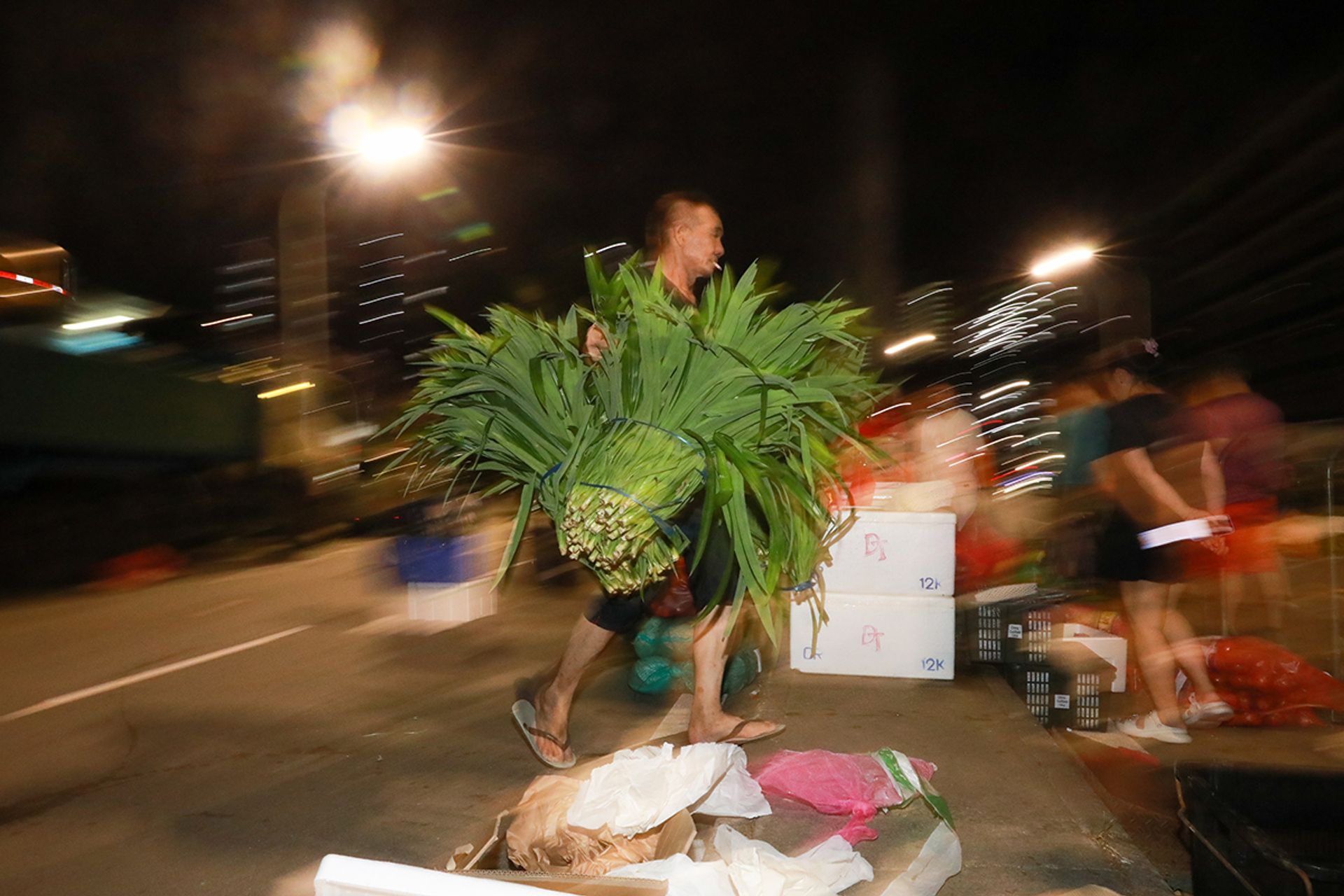Mr Yang unloading boxes of pandan leaves on July 1.
