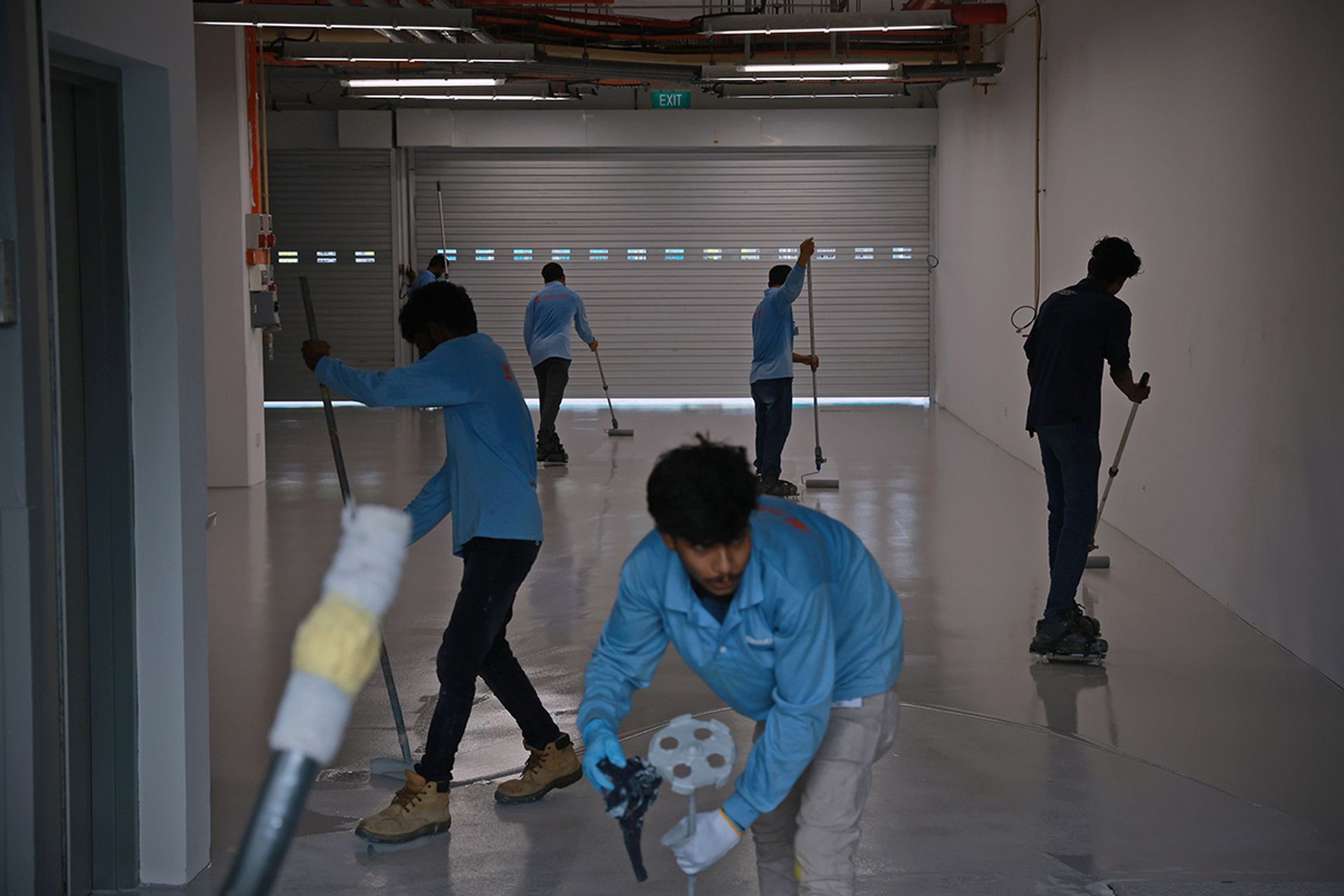 Workers painting the floor of a garage at the F1 Pit Building on Aug 19.