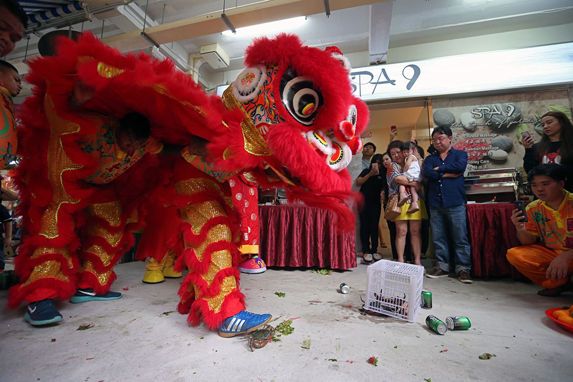 A "plucking the green" component of a performance involving crabs at the official opening of a spa in Holland Drive in 2017. ST FILE PHOTO: NEO XIAOBIN