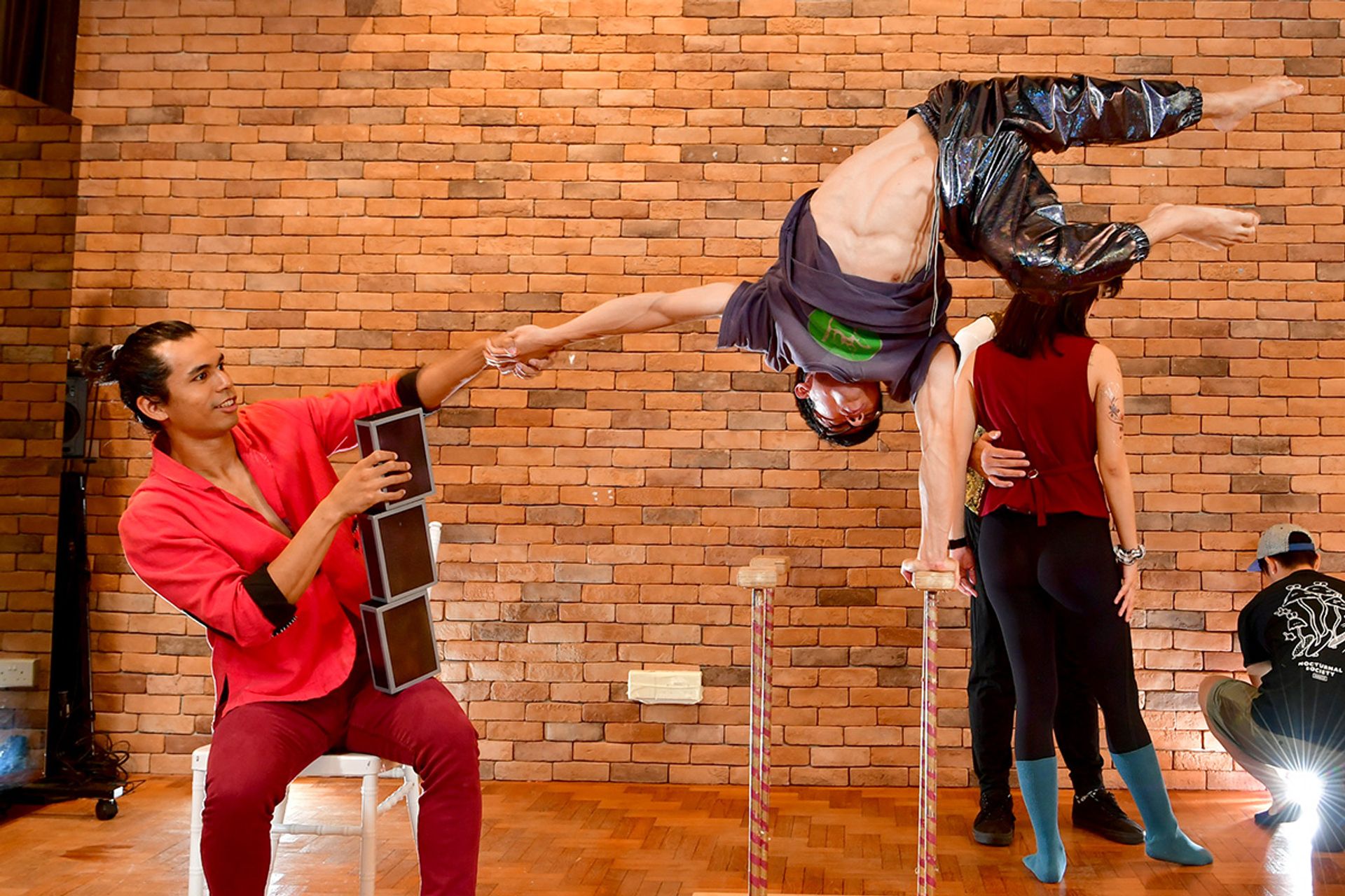 Nachos Nyan Lin Cho (left) helping Foo Ping adjust his posture during the photo shoot. ST PHOTO: DESMOND FOO