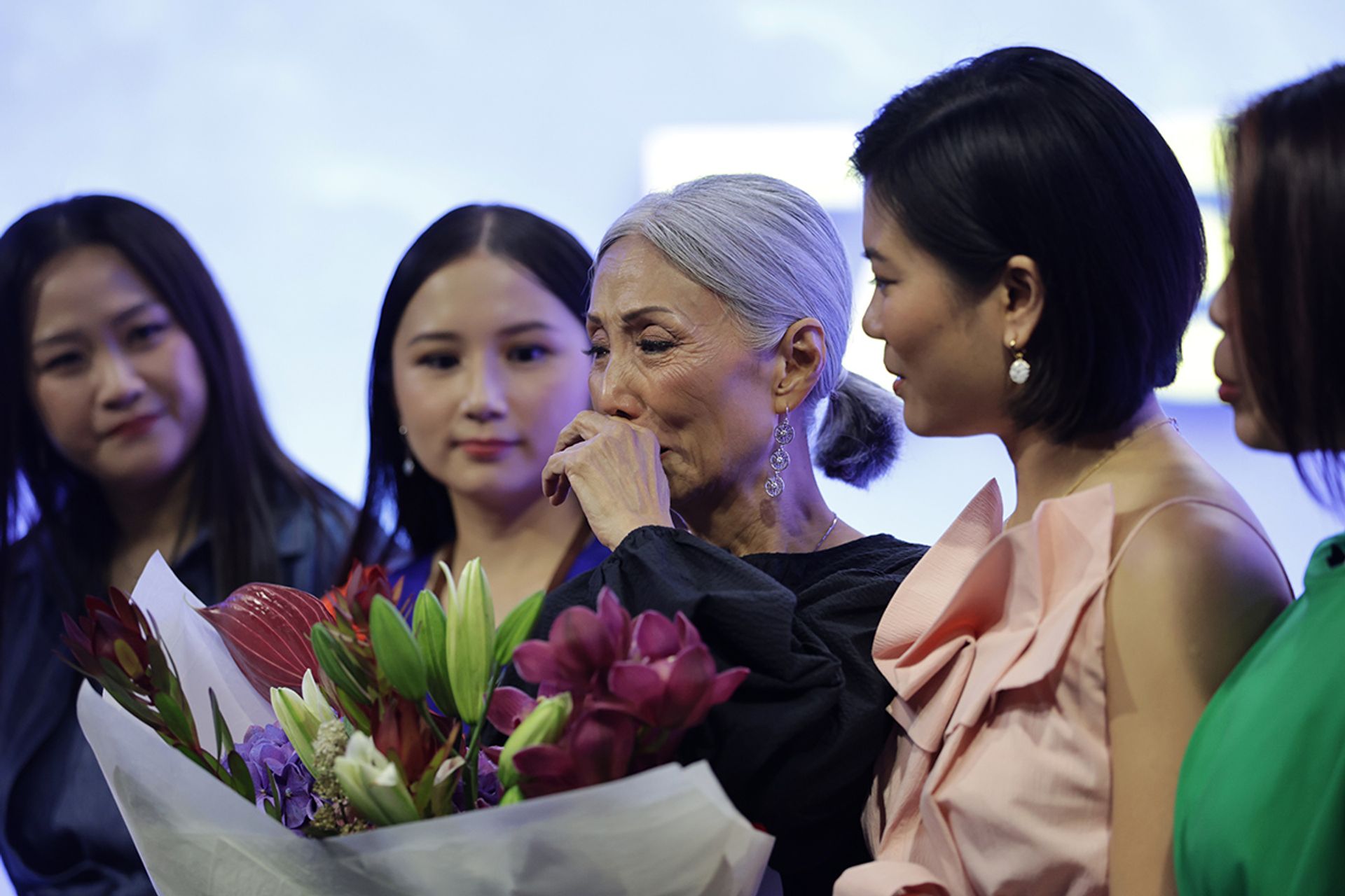 An emotional Ms Ong Bee Yan received a bouquet at the close of Fashion For Cancer, from a group of breast cancer survivors who call themselves "boob sisters" and took part in the show.