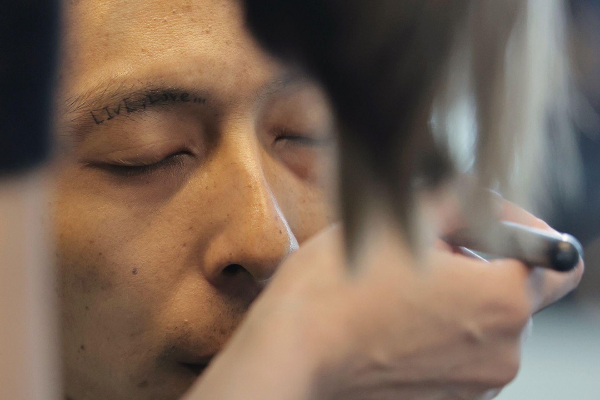 Mr Chia has a tattoo on his right brow ridge that says “Live, Love…”.