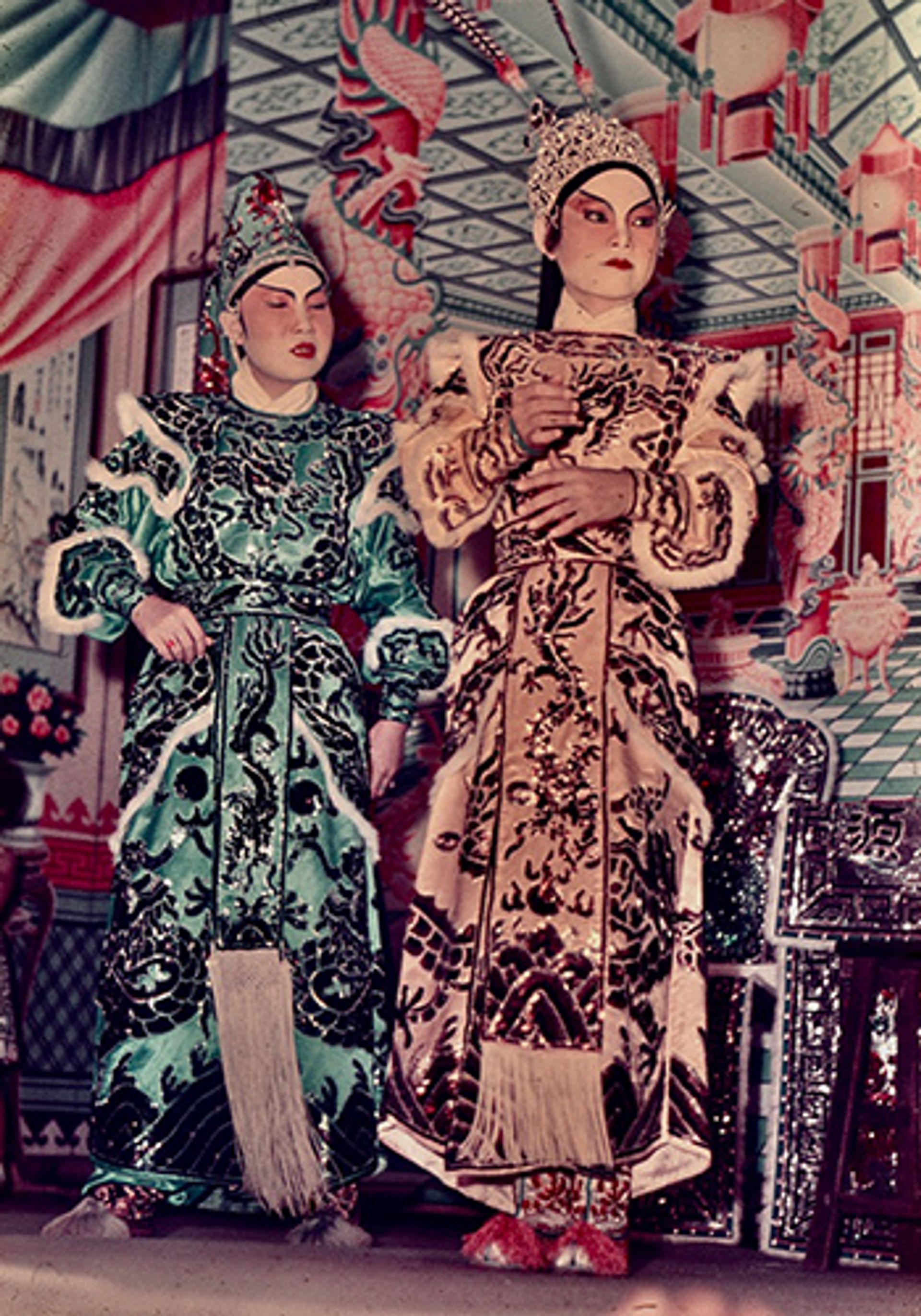 Hungry Ghost Month by the Singapore River, 1961. Chinese opera performers prepare for the evening's performance, as a tongkang is moored to the quayside to accommodate additional spectators.
