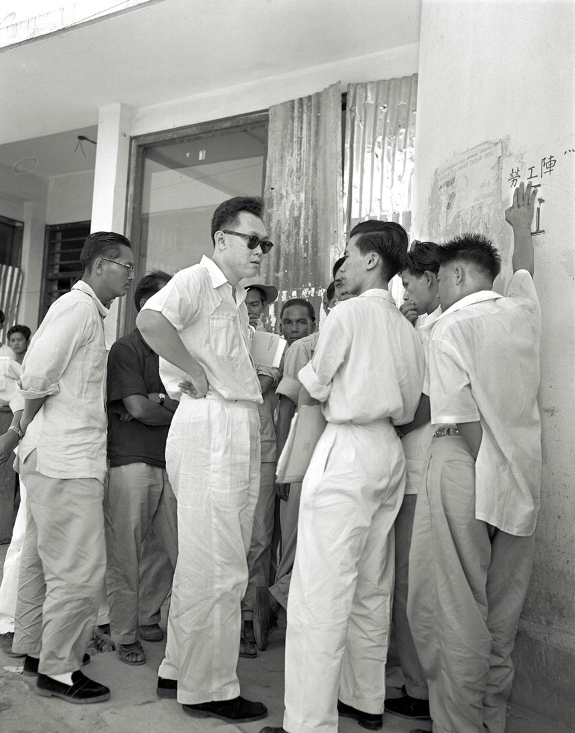 Mr Lee (in sunglasses) was legal adviser to the Singapore Bus Workers’ Union when it went on strike in April 1955. He is seen here with the union’s leader, Mr Lim Chin Siong (facing Mr Lee), on May 4. The workers had gone against Mr Lee’s advice and called the strike before their 14-day notice of a strike had expired. ST Photo: N.J. Cotterell