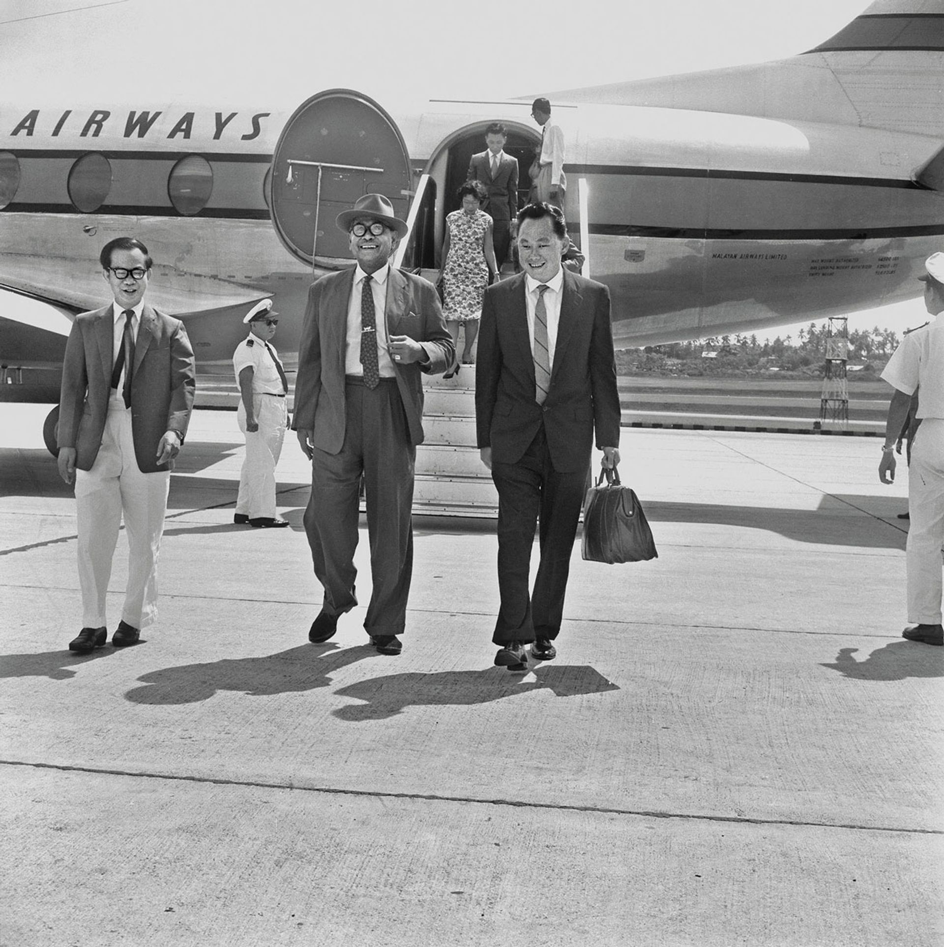Arriving together with Malayan Prime Minister Tunku Abdul Rahman (centre) at Paya Lebar Airport, where they were received by Deputy PM Toh Chin Chye (left) on Oct 24, 1961. Mr and Mrs Lee were returning from a two-week holiday in Kuala Lumpur, while the Tunku, who was on his way to Vietnam, would visit London the next month for talks on the formation of Malaysia. ST Photo: Chew Boon Chin
