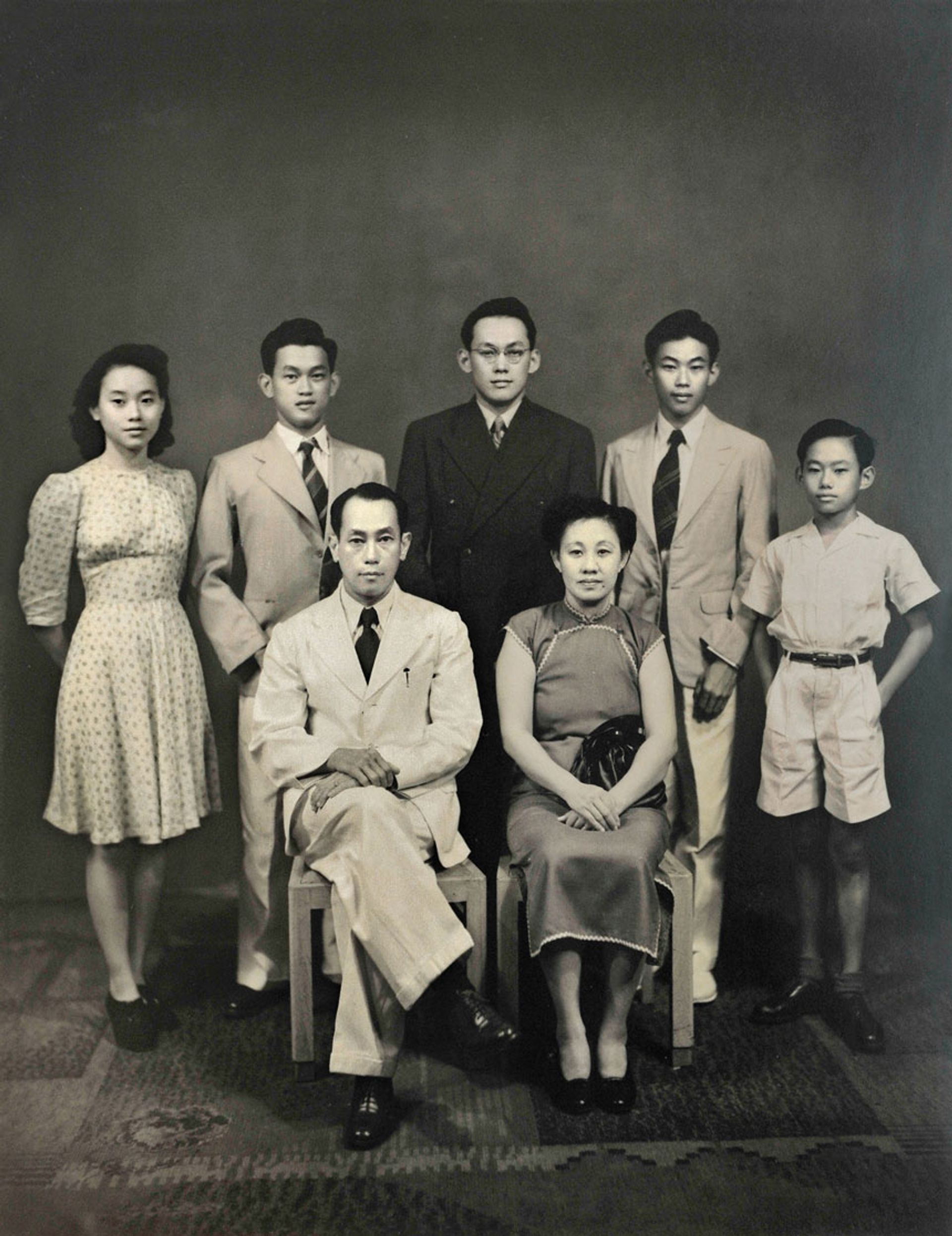 The night before Mr Lee (standing, centre) left for England, his family had a steak dinner at Pavilion Steakhouse in Orchard Road before walking to nearby Lloyd Studio for this family portrait, taken in 1946. (Clockwise from top left) Siblings Monica, Dennis, Freddy and Suan Yew, and parents Chua Jim Neo and Lee Chin Koon. Source: Lee Kuan Yew