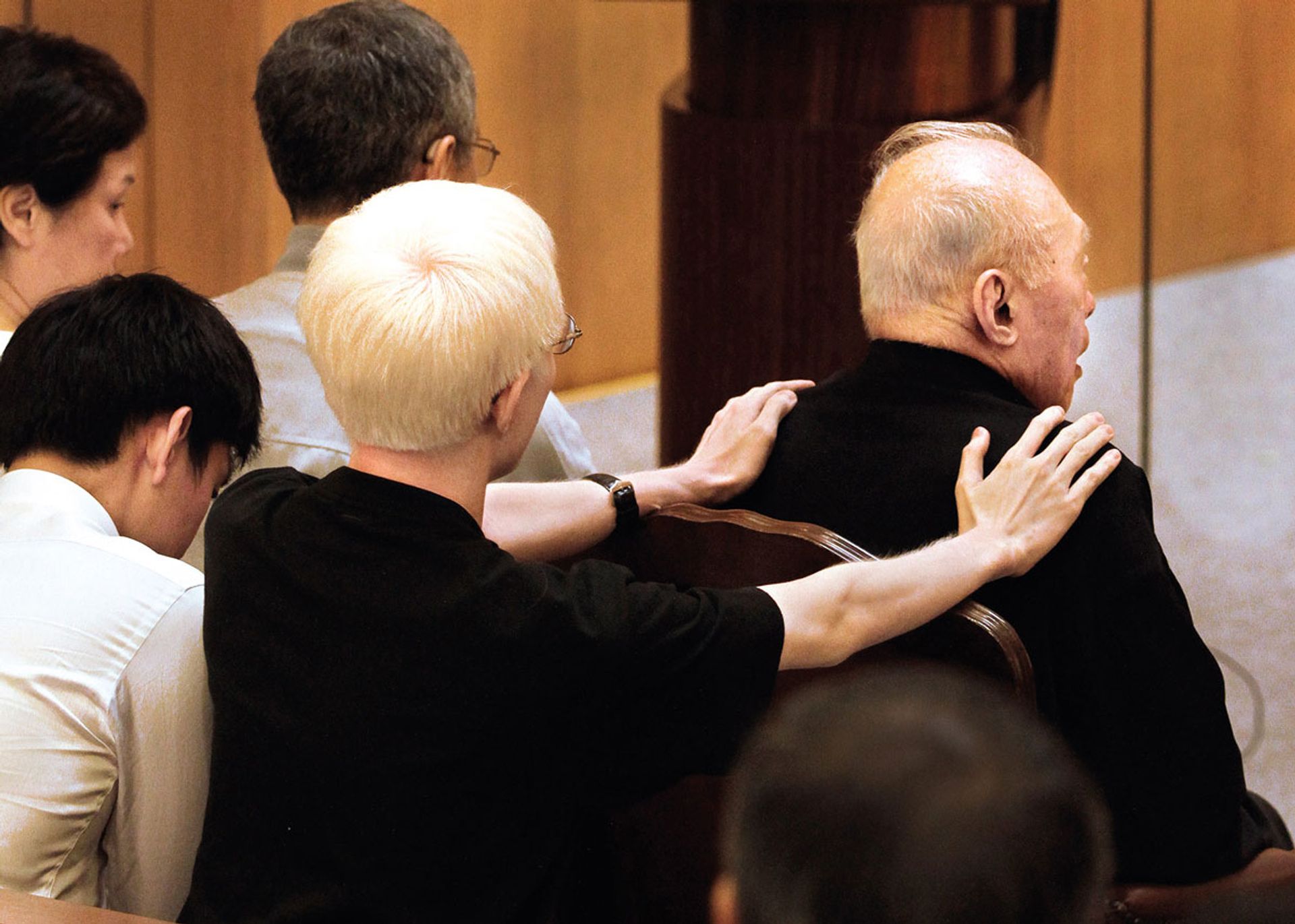 Grandson Yipeng comforting Mr Lee during the funeral service of Mrs Lee, who died at the age of 89 on Oct 2, 2010, following a long illness after suffering three strokes. ST Photo: Terence Tan