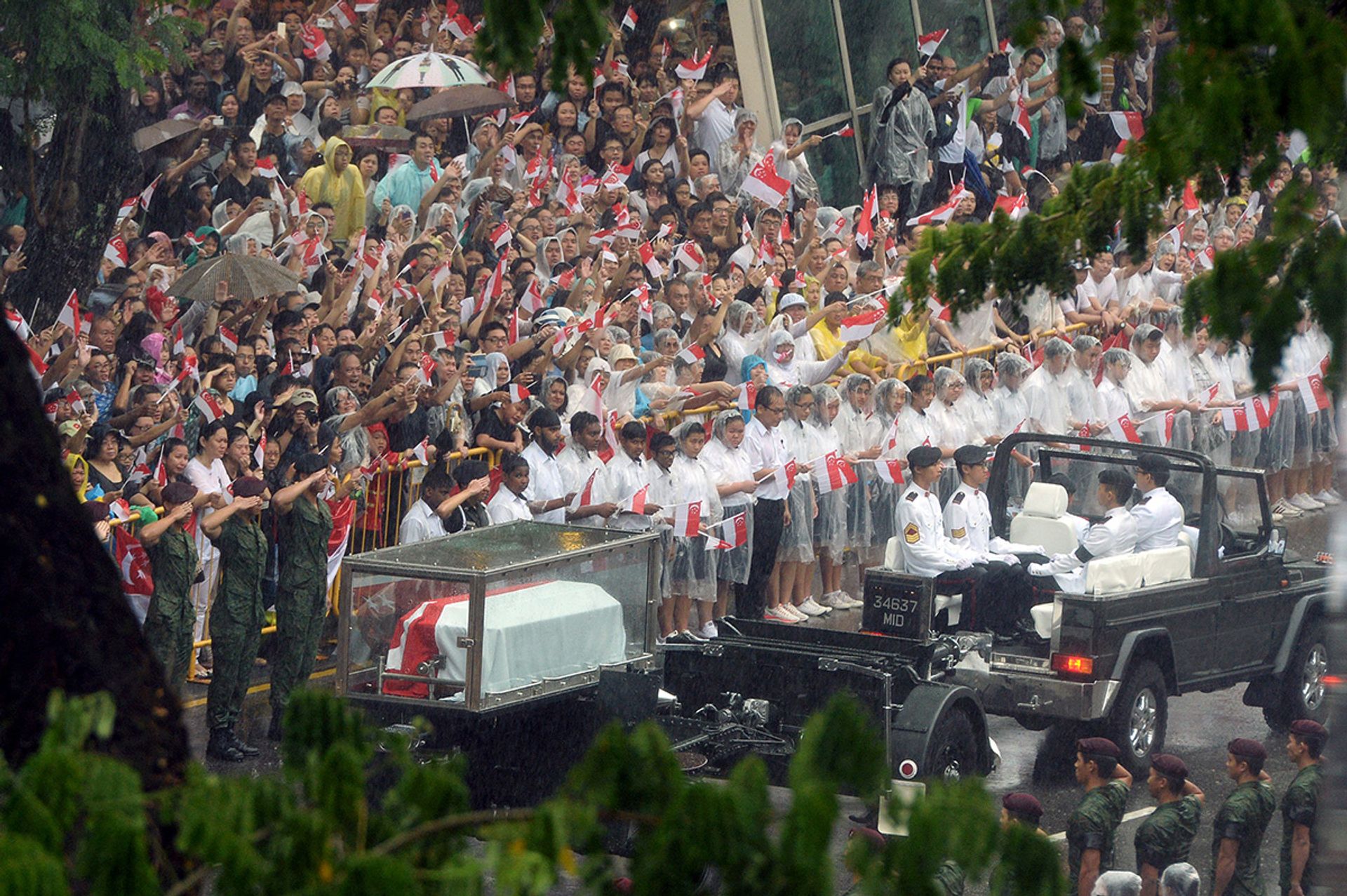Singaporeans bidding Mr Lee a final farewell as the cortege filed past City Hall in Stamford Road on March 29, 2015. In all, an estimated 100,000 people lined the streets under pouring rain as the cortege made its way along the 15.4km-long route from Parliament House to the University Cultural Centre in Kent Ridge for the state funeral. ST Photo: Desmond Foo