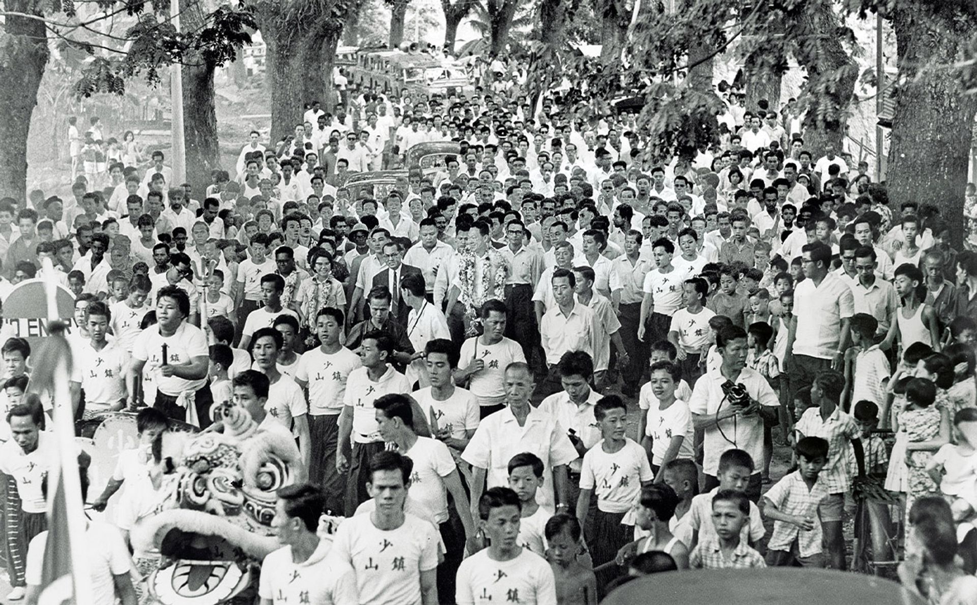 Mr Lee (centre, garlanded) during a walkabout in Tanjong Pagar constituency between 1962 and 1963. Source: People’s Action Party