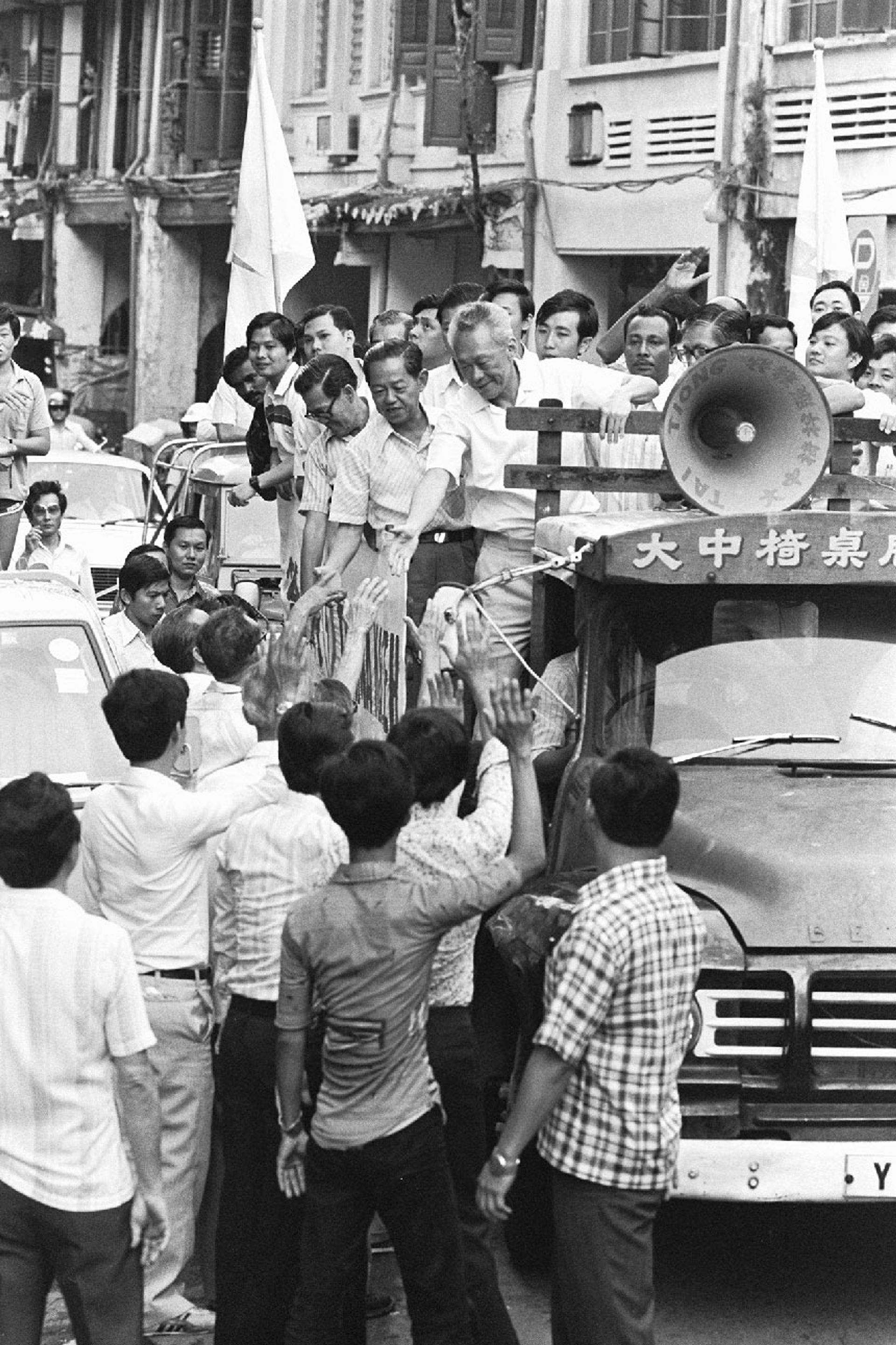 Mr Lee shaking the hands of Tanjong Pagar residents during his victory parade on Dec 24, 1980. ST Photo: Francis Ong
