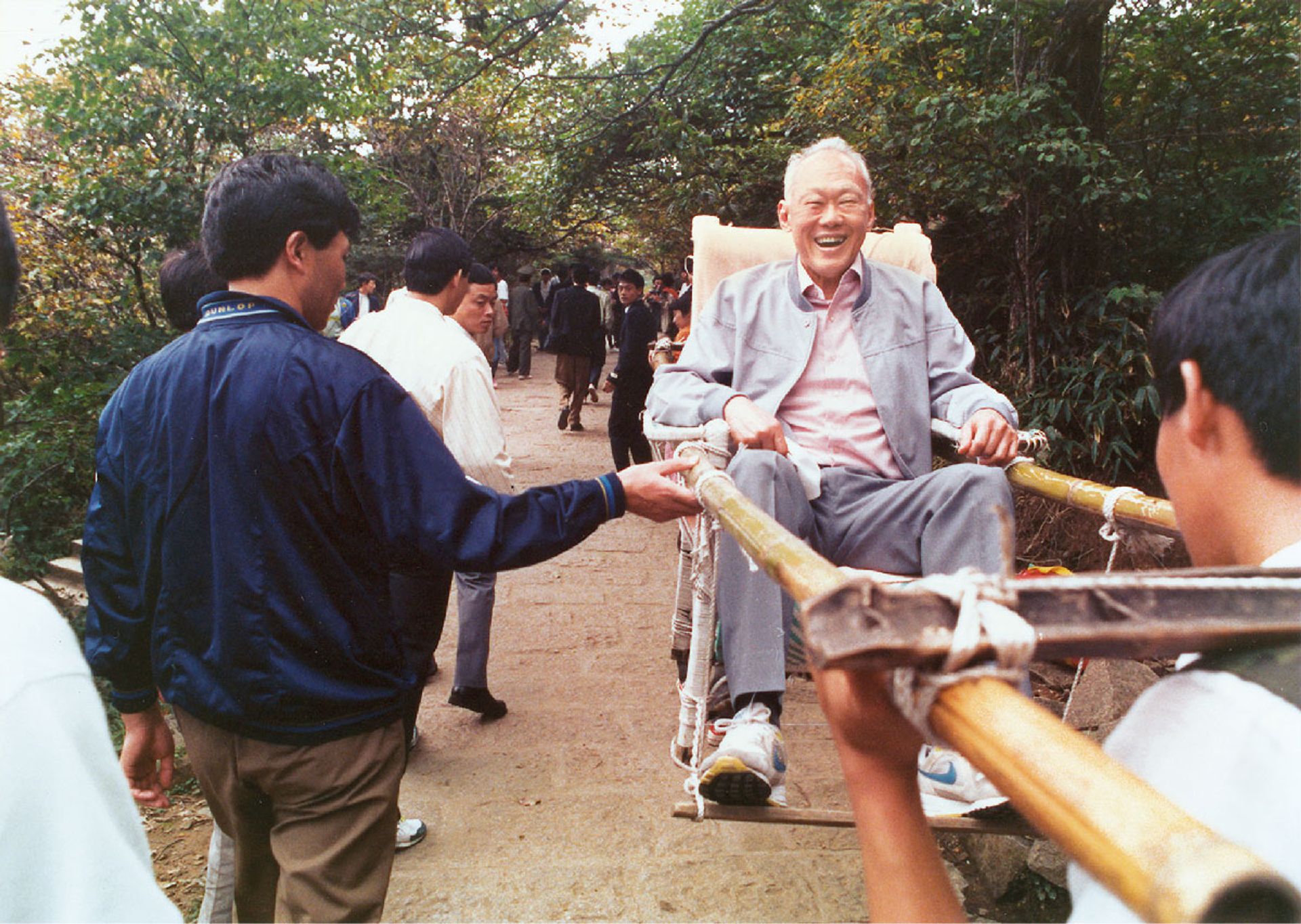 Thrilled by the novelty of being lifted in a sedan chair, Mr Lee was transported up to the top of Huangshan, a mountain range in Anhui province in eastern China, for its magnificent view during his visit in October 1992. ST Photo: Albert Sim