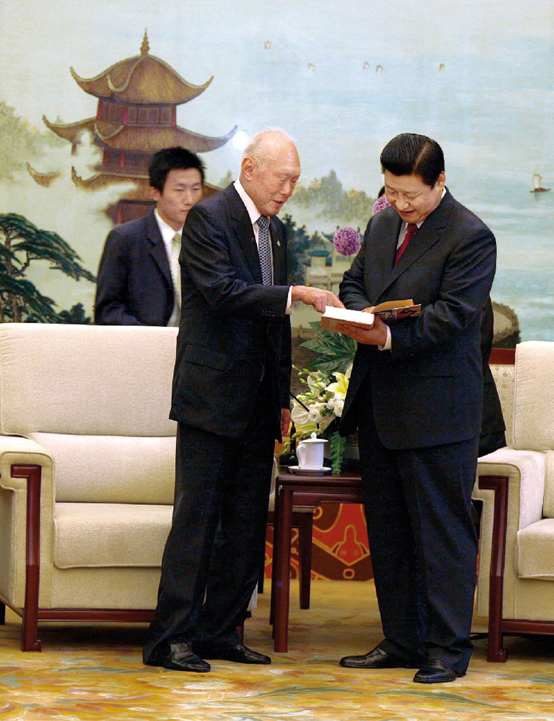 Mr Lee presenting a copy of his memoirs in Chinese to Vice-President of the People’s Republic of China Xi Jinping when they met during the Beijing Olympics in August 2008. Mr Xi became president in March 2013. ST Photo: Chua Chin Hon