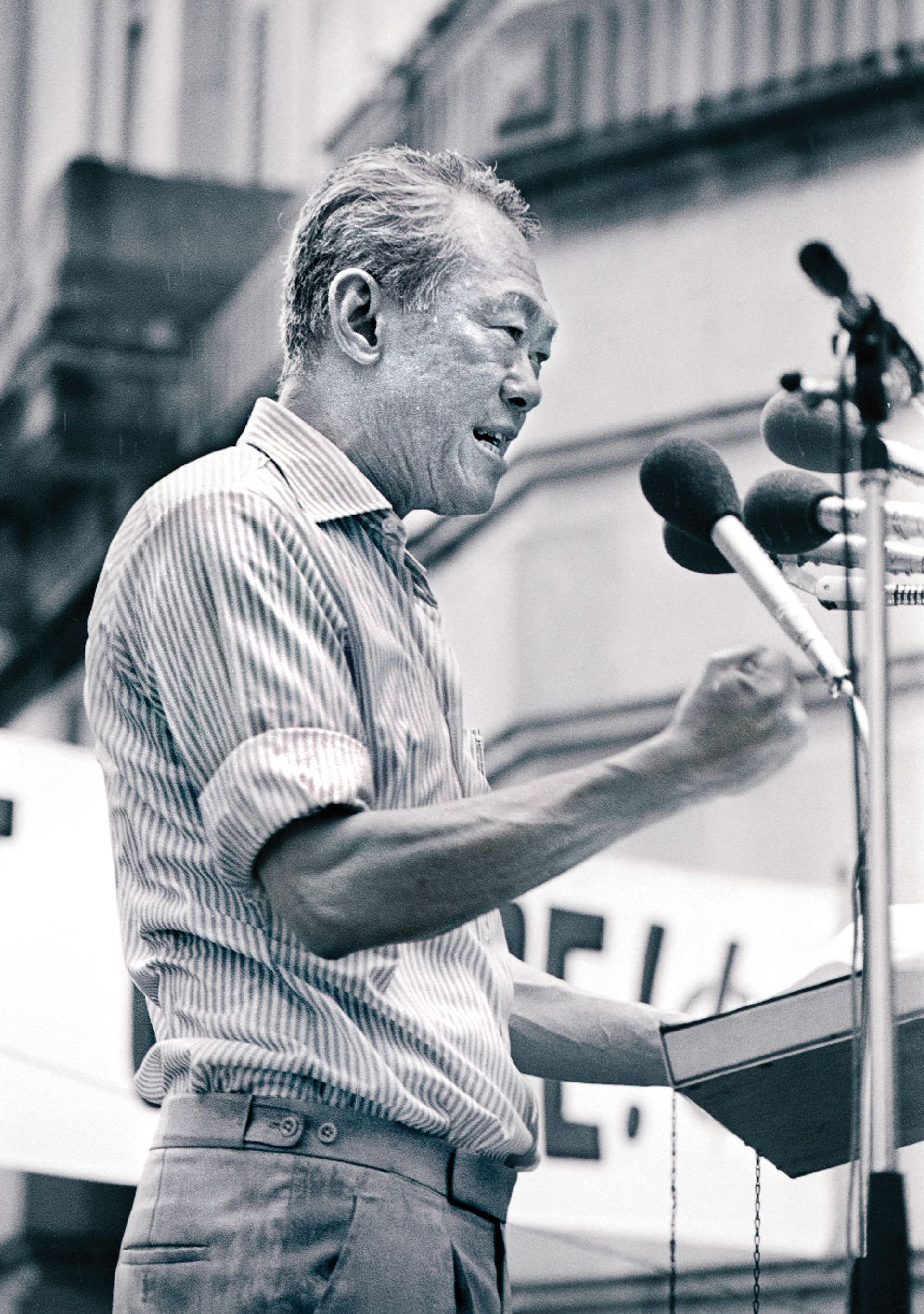 Waving his fist and thumping his lectern, Mr Lee’s fiery oratory could not be doused by the heavy rain on Dec 19, 1980. ST Photo: Tan Wee Him
