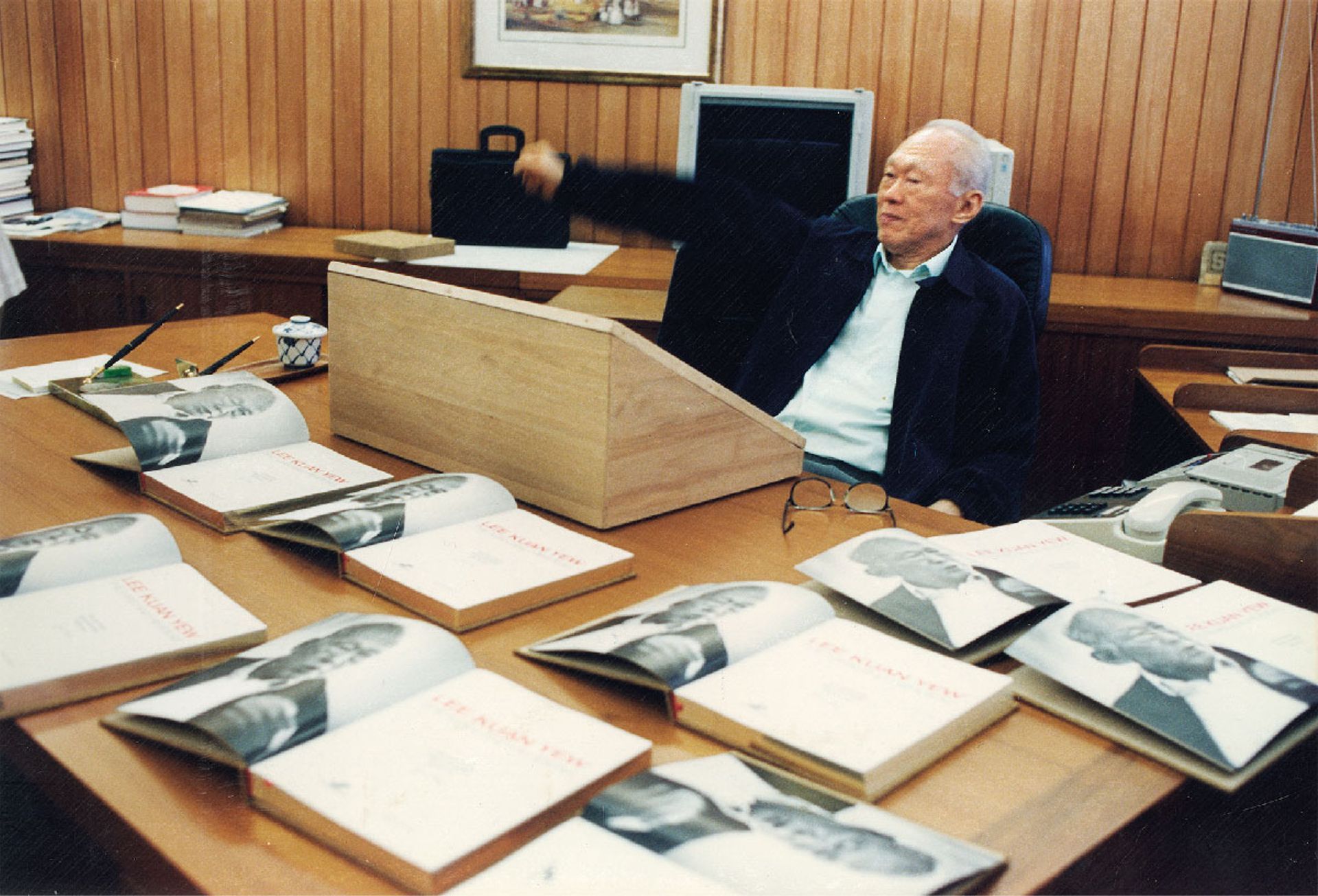 Mr Lee taking a moment to stretch while signing copies of Lee Kuan Yew: The Man And His Ideas in his office on his 74th birthday on Sept 16, 1997. ST Photo: George Gascon