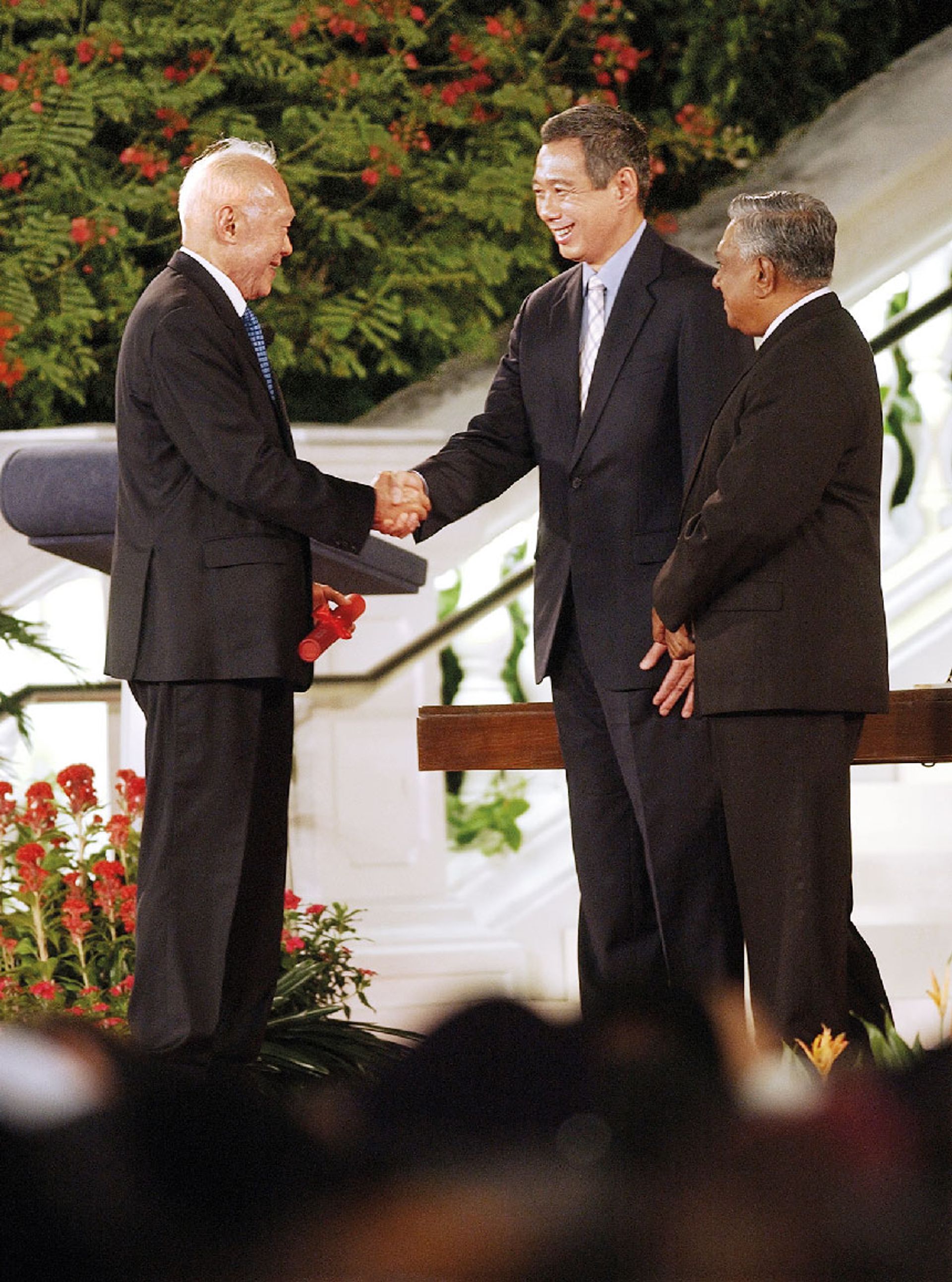 Mr Lee congratulating his son, Mr Lee Hsien Loong, after the latter was sworn in as Singapore’s third prime minister on Aug 12, 2004. The elder Mr Lee was appointed Minister Mentor by President S R Nathan (right). ST Photo: Joyce Fang