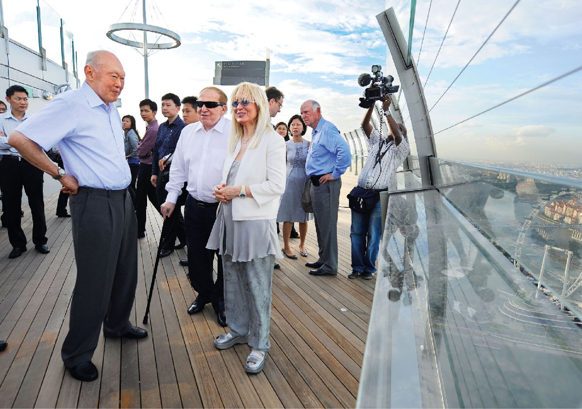 Taking in the view from Marina Bay Sands’ (MBS) SkyPark Observation Deck on June 22, 2010. With him are Mr Sheldon Adelson (with cane), president and chief executive of Las Vegas Sands, which developed MBS, and his wife Miriam. ST Photo: Caroline Chia