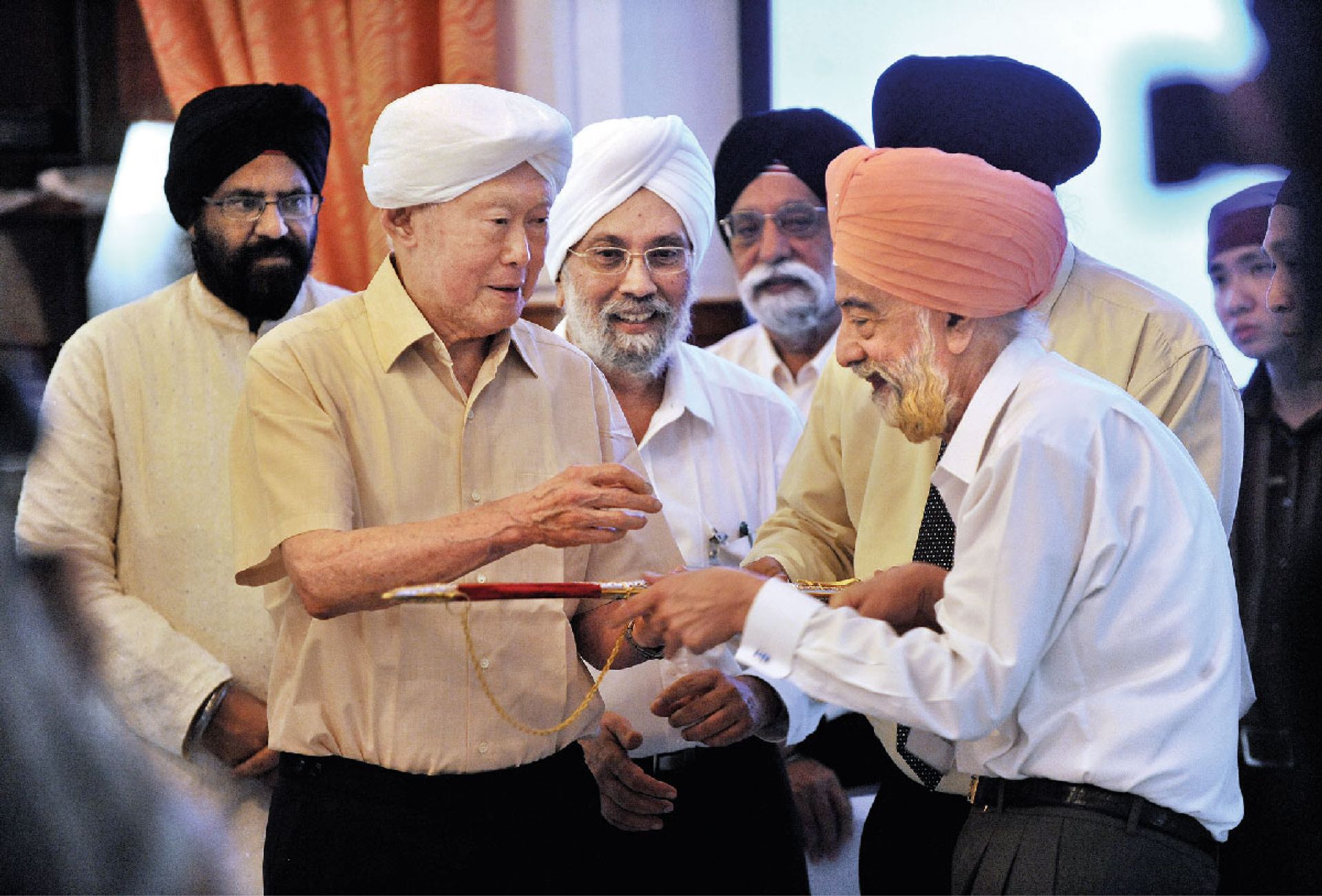 Mr Lee receiving a ceremonial sword symbolising respect, or a kirpan, from Sikh businessman Kartar Singh Thakral at Bhai Maharaj Singh Memorial Temple on July 3, 2010. Keenly aware of the volatile nature of racial and religious issues, Mr Lee made an effort to reach out to different communities. ST Photo: Ng Sor Luan