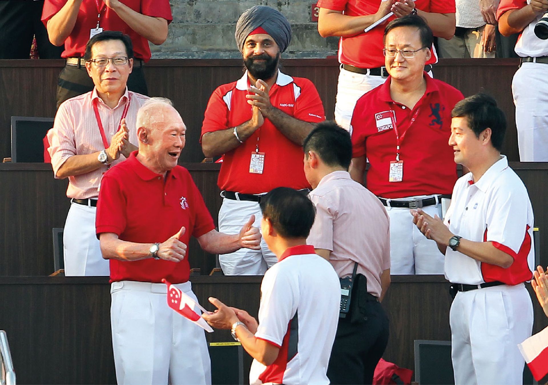 Mr Lee giving spectators two thumbs-up as he arrived to the loudest cheers and a standing ovation at The Float@Marina Bay during the 2012 National Day Parade. ST Photo: Seah Kwang Peng