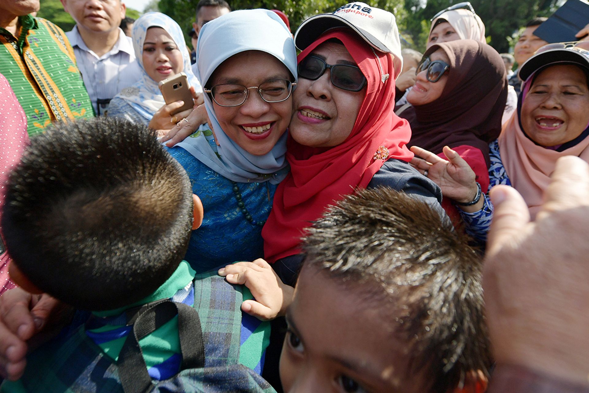 President Halimah with Marsiling resident Jainah Awang, one of about 80 residents from Marsiling-Yew Tee GRC whom the President met at the Istana open house on Oct 22, 2017. ST PHOTO: NG SOR LUAN